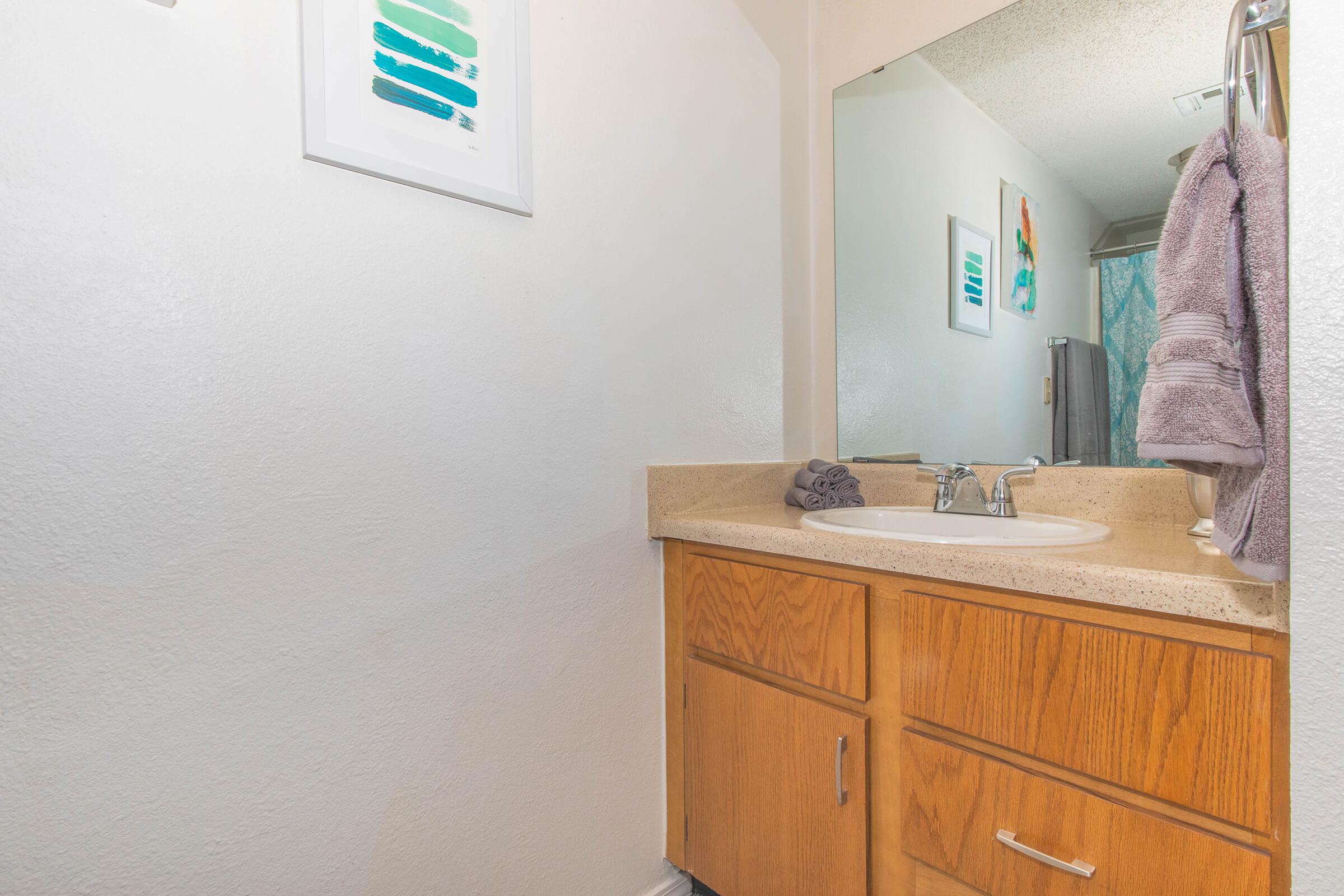 a kitchen with a sink and a mirror