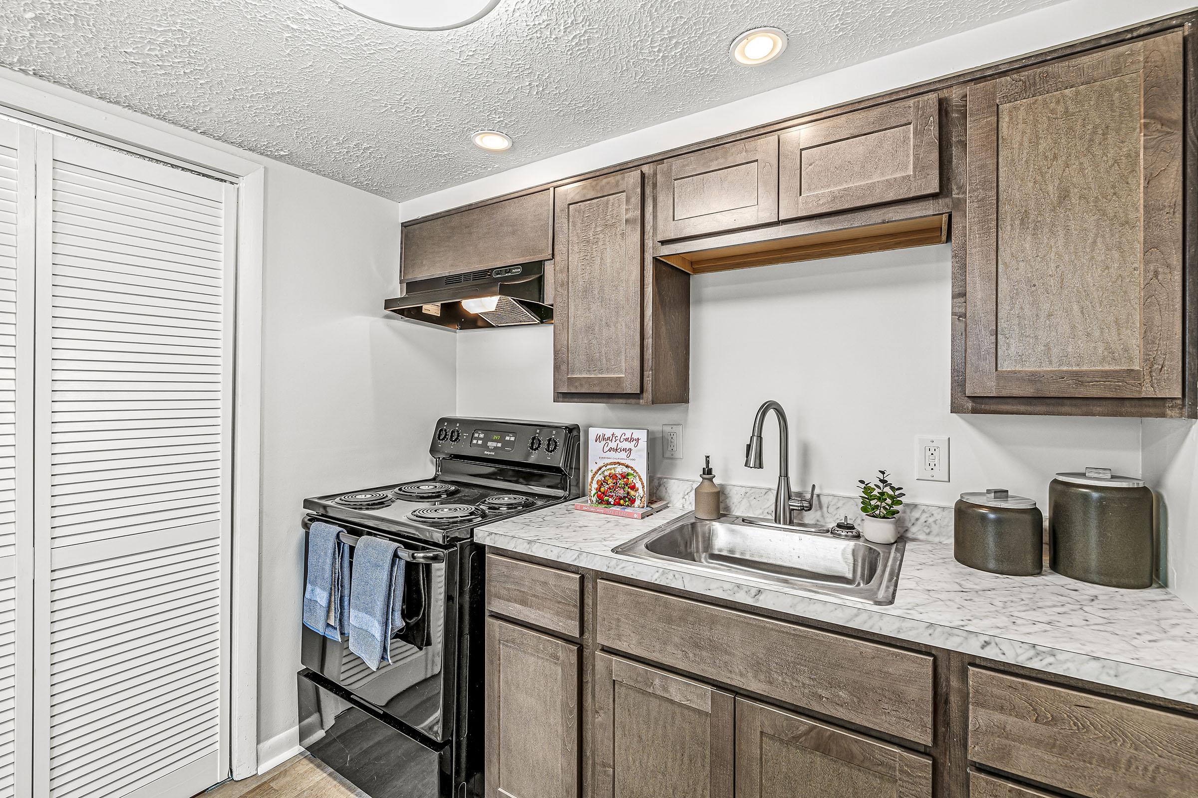 a kitchen with a sink and a mirror