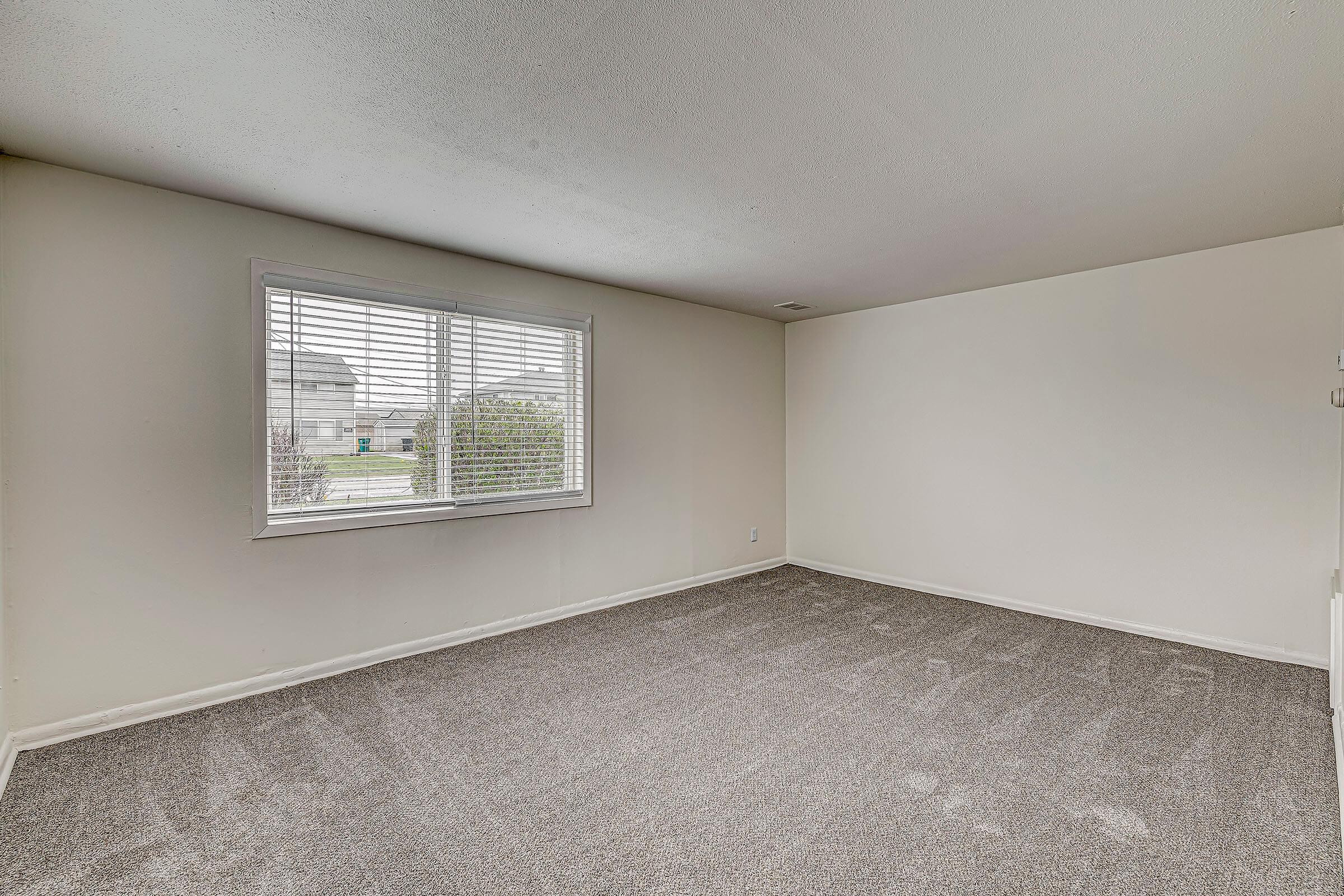 a bedroom with a large window