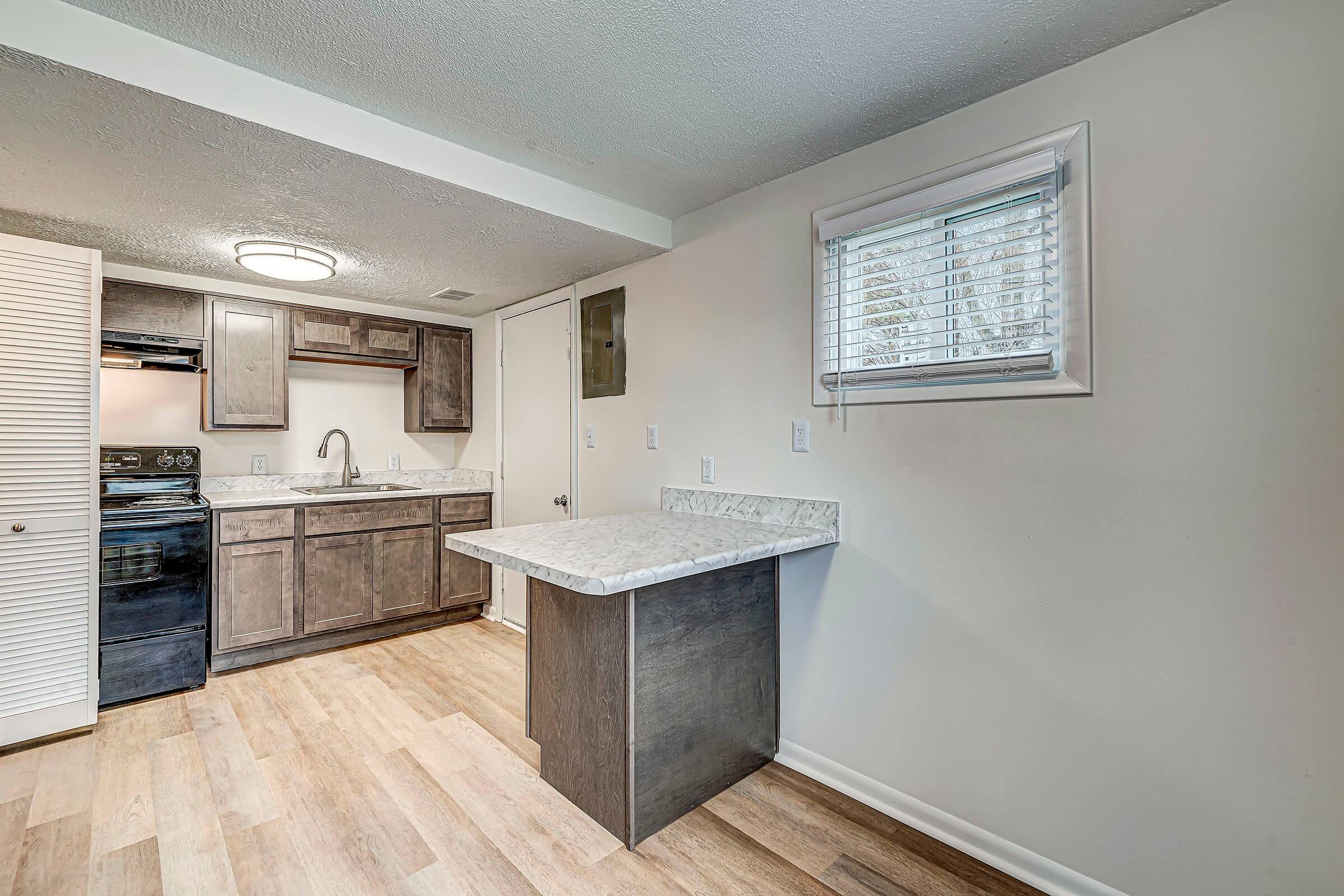 a kitchen with a stove top oven sitting inside of a building