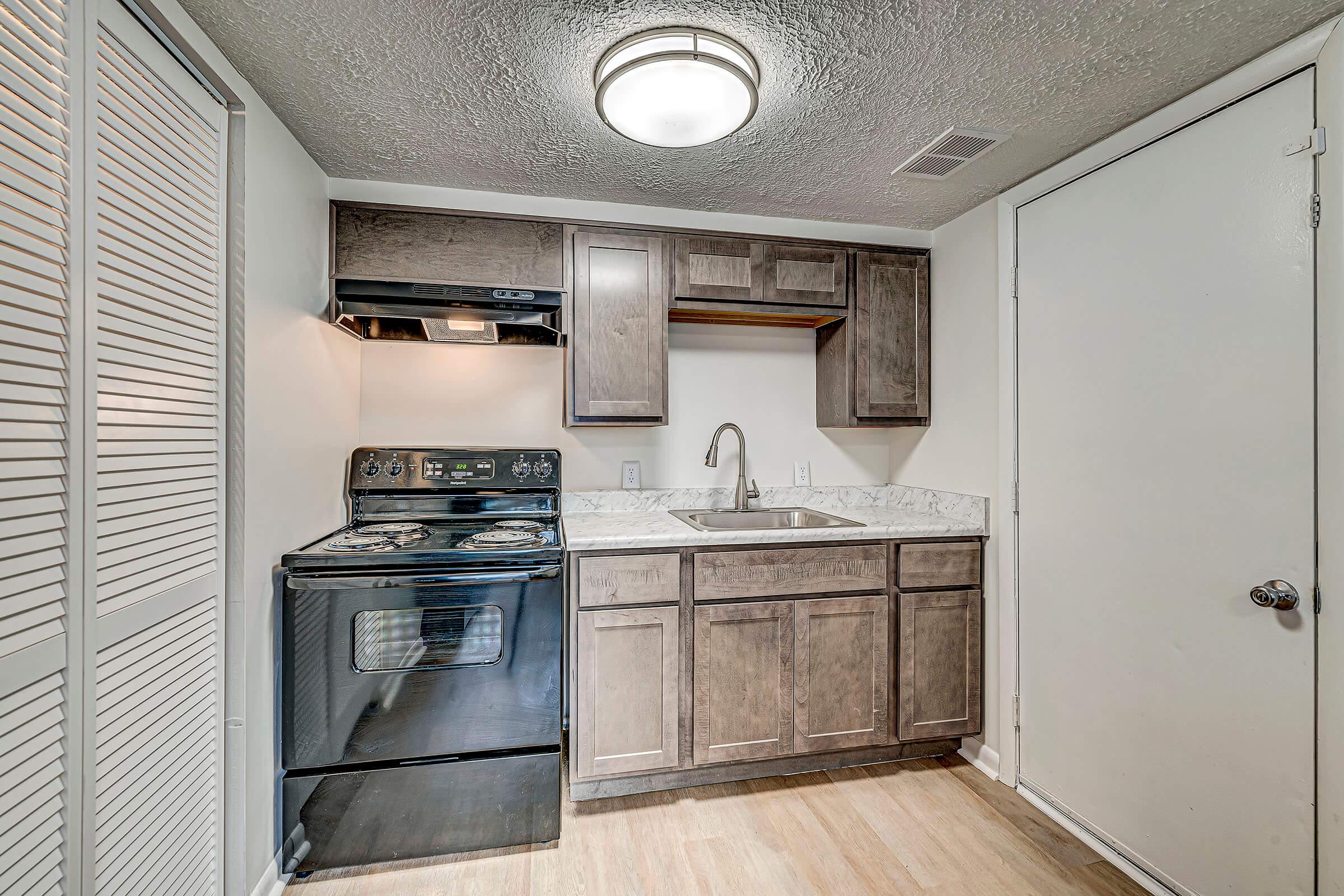 a stove top oven sitting inside of a kitchen