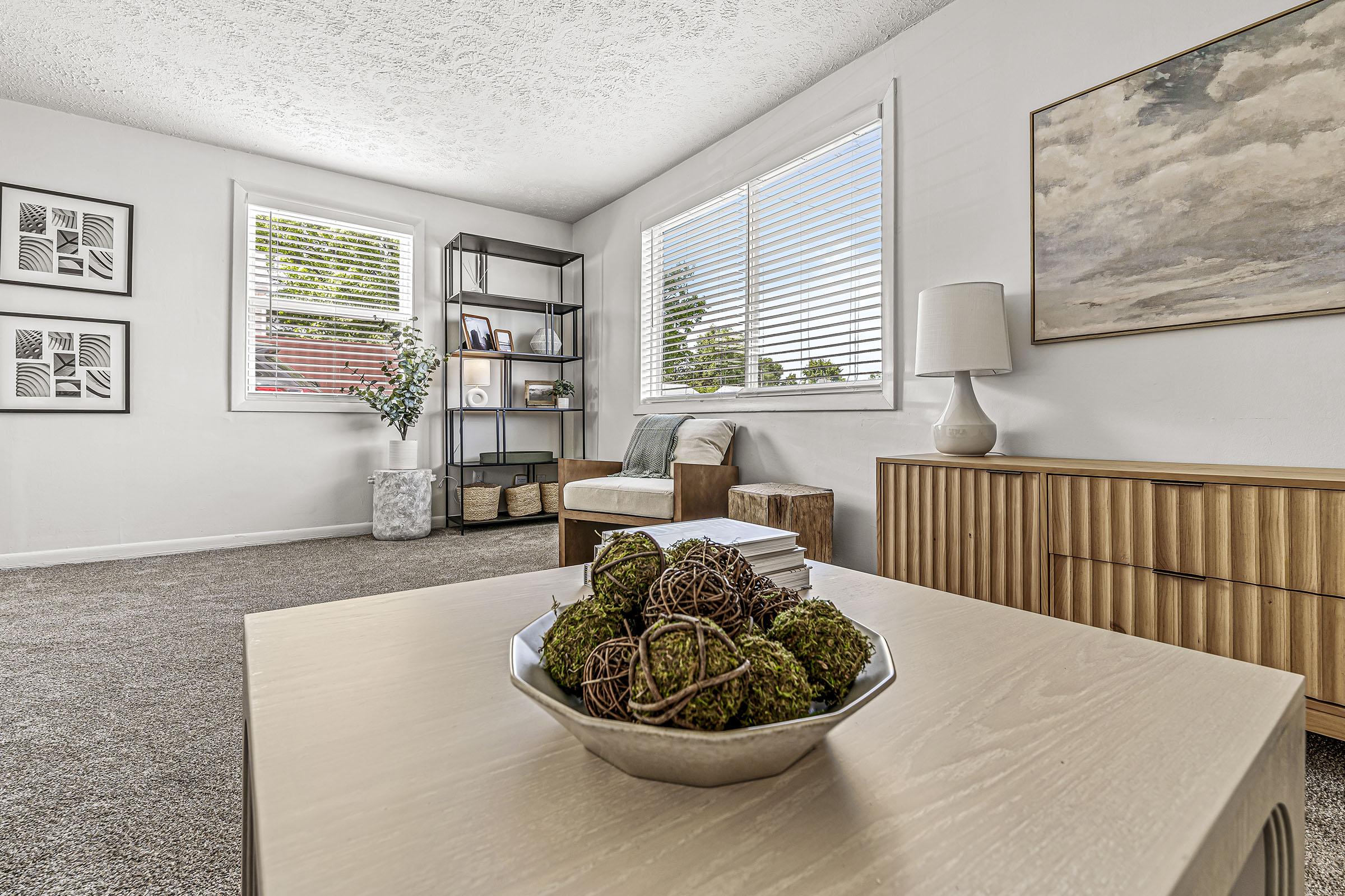 a living room filled with furniture and a large window