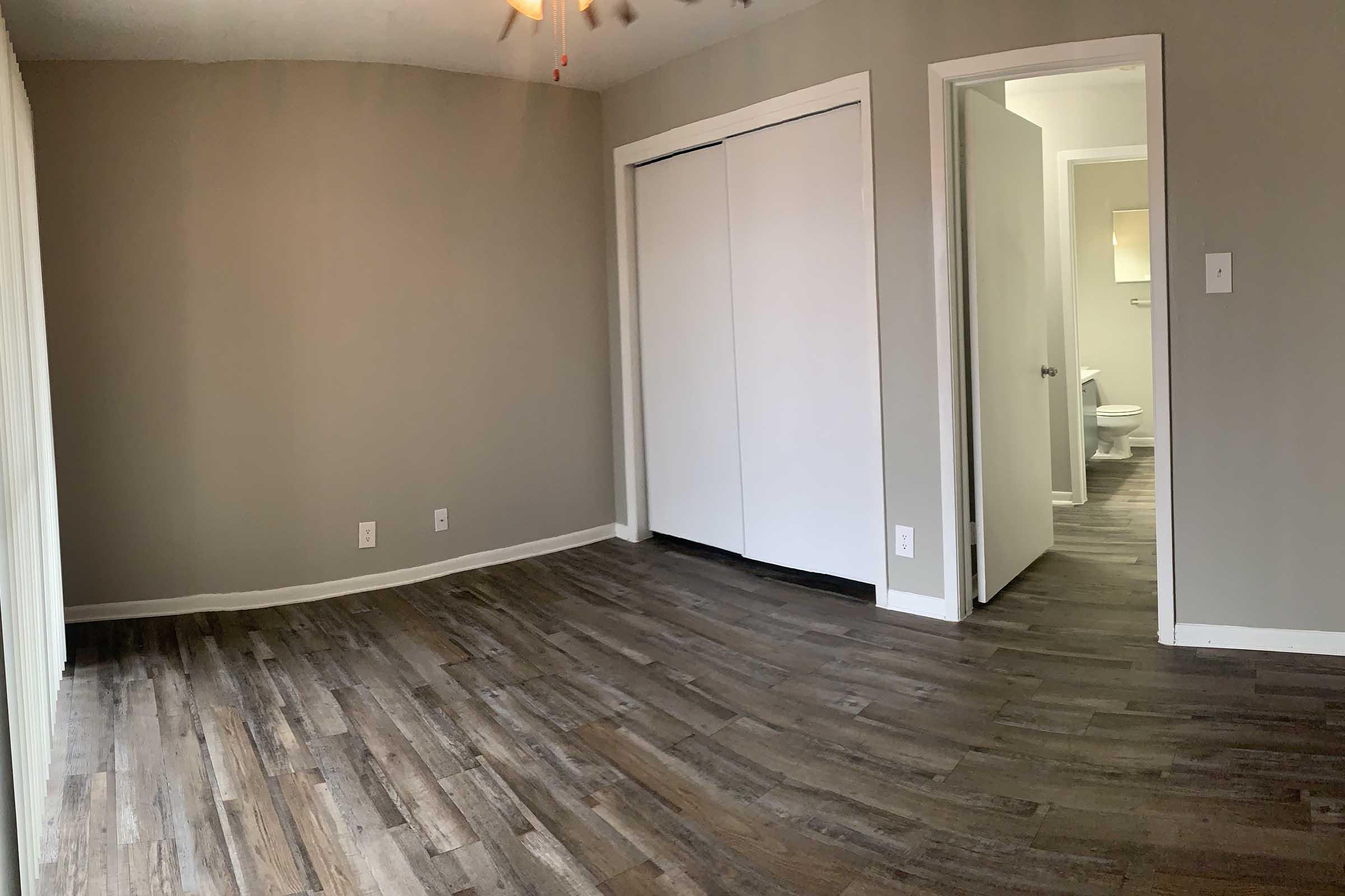 a large empty room with a wooden floor