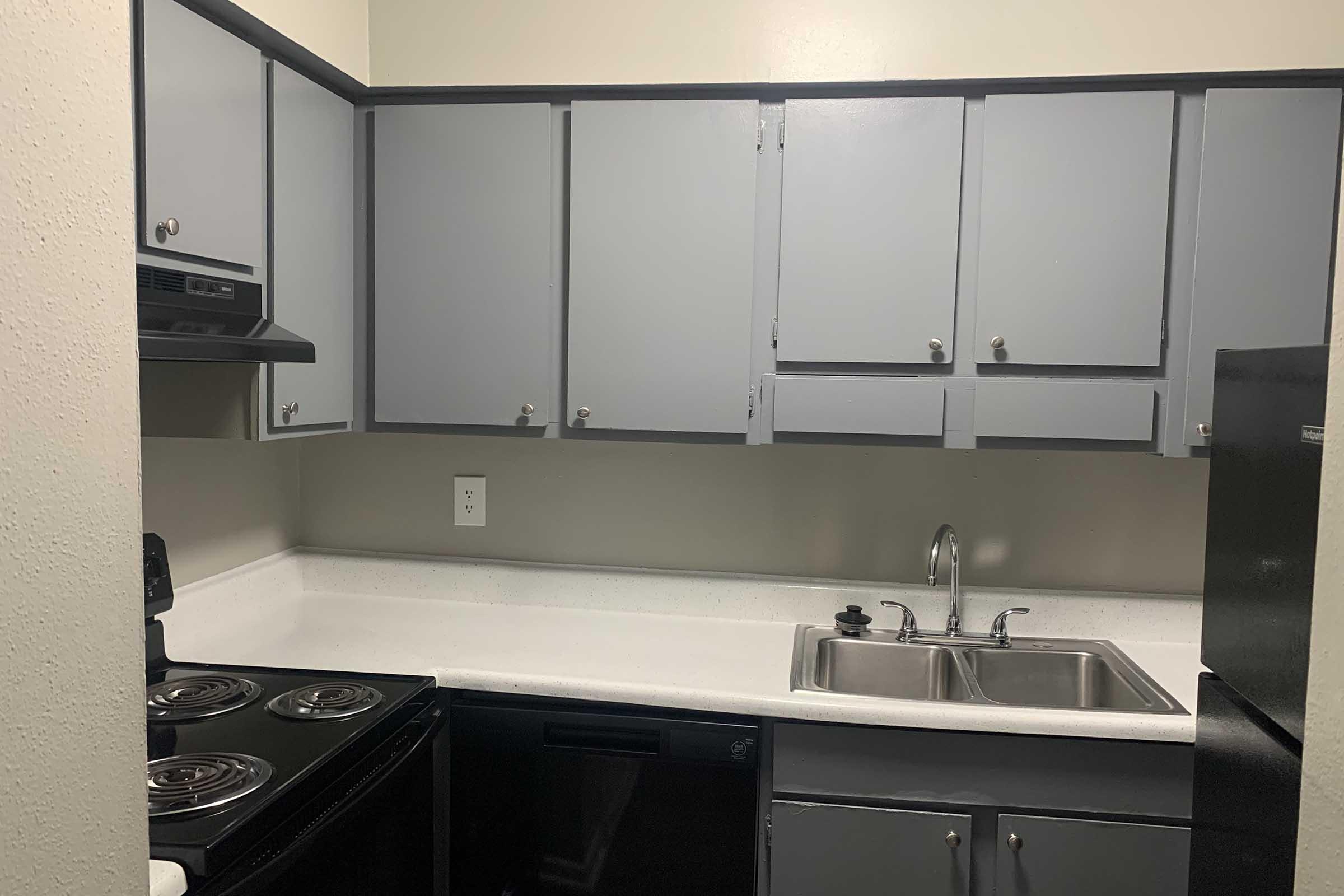 a kitchen with a sink and a mirror