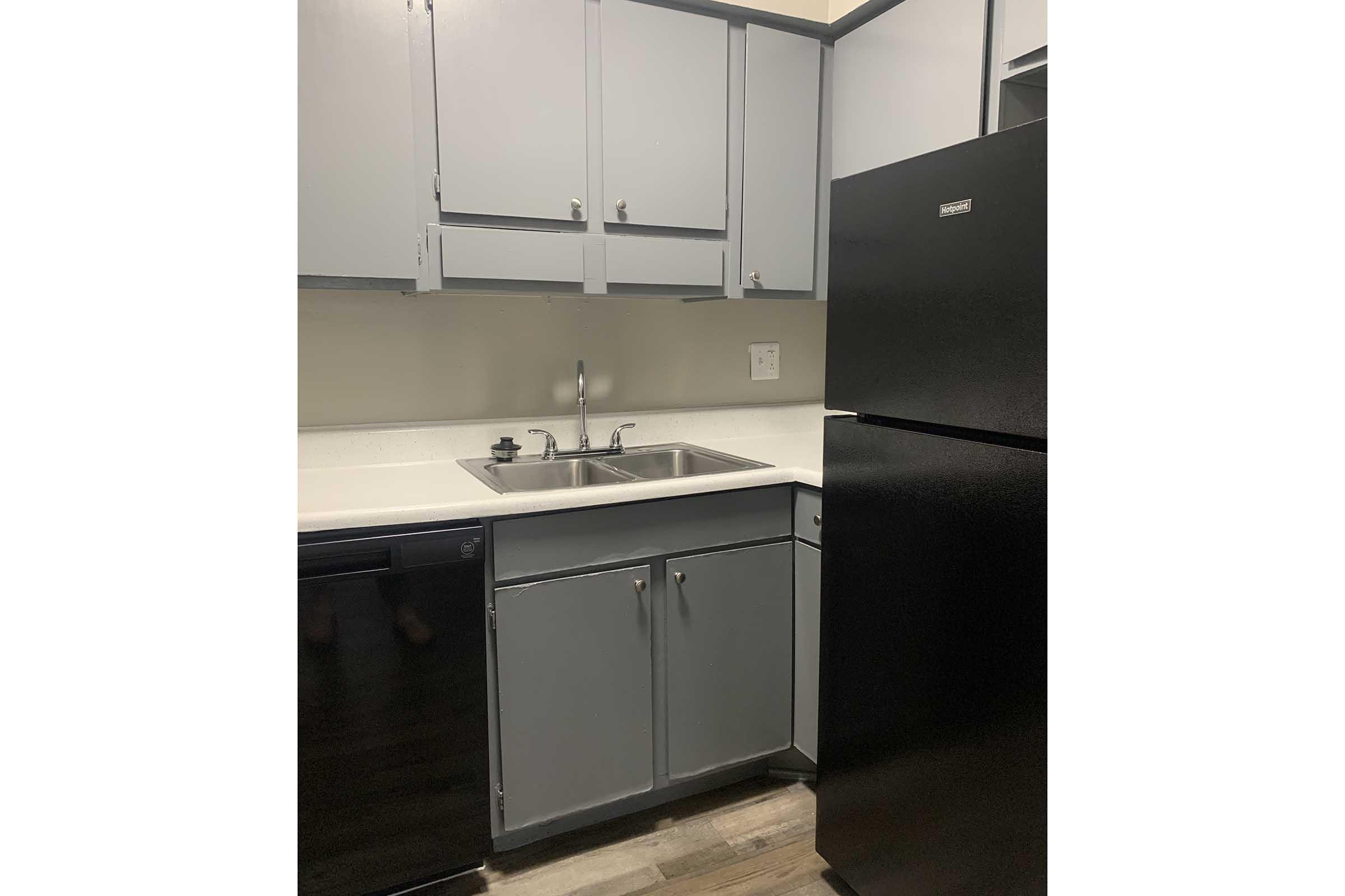 a kitchen with a sink and a refrigerator