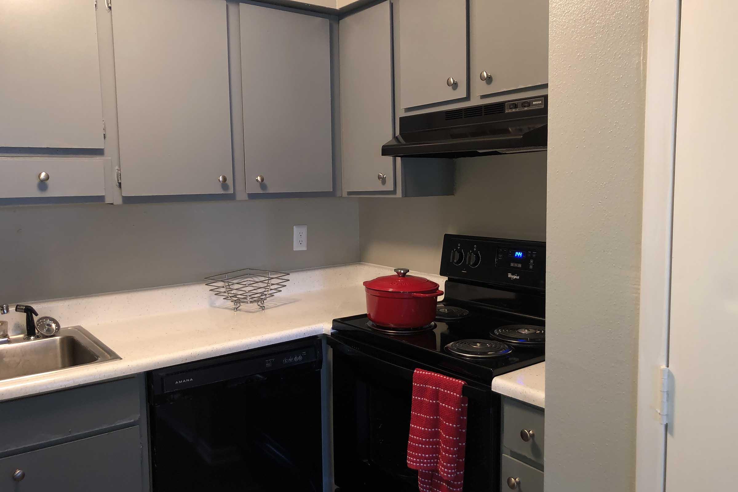 a stove top oven sitting inside of a kitchen