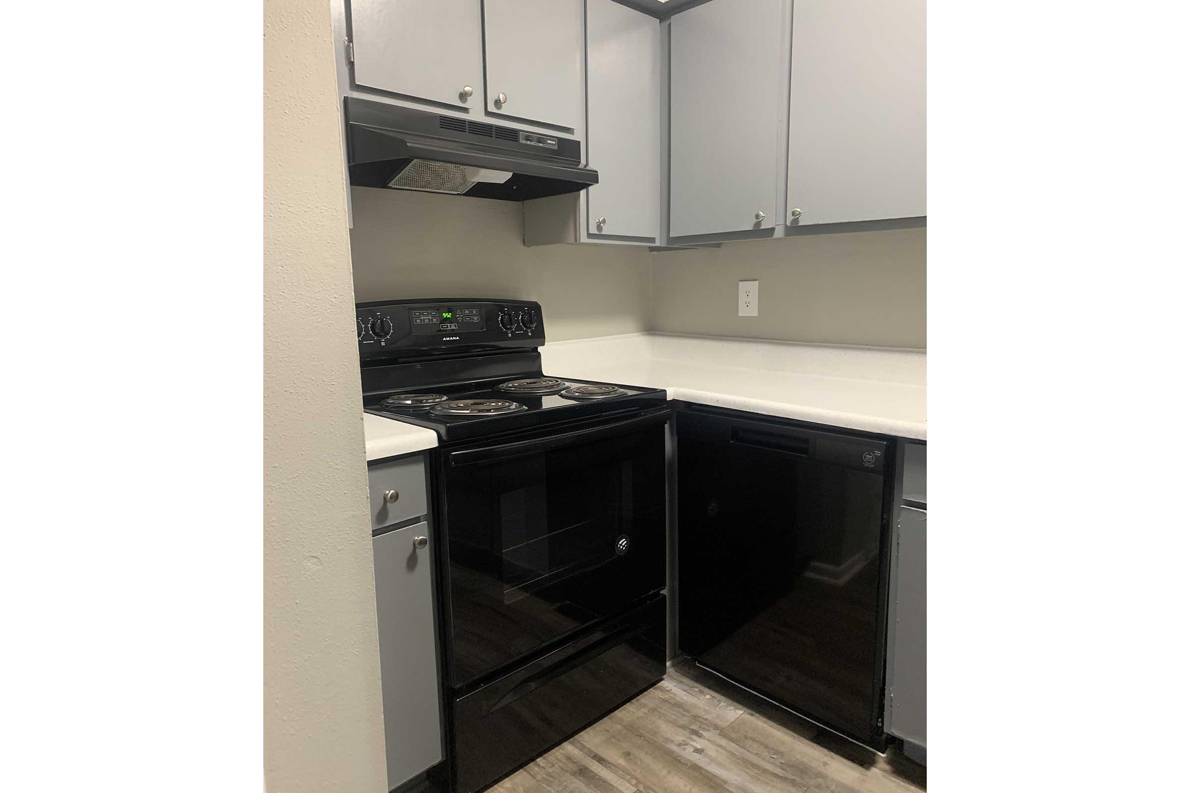 a stove top oven sitting inside of a kitchen