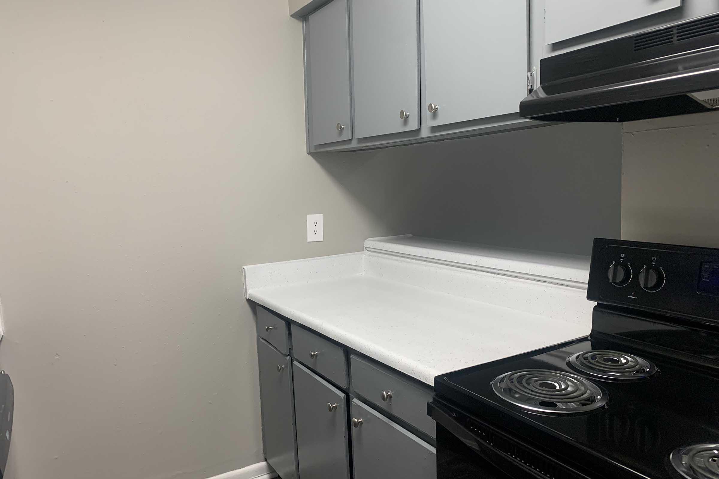 a stove top oven sitting inside of a kitchen