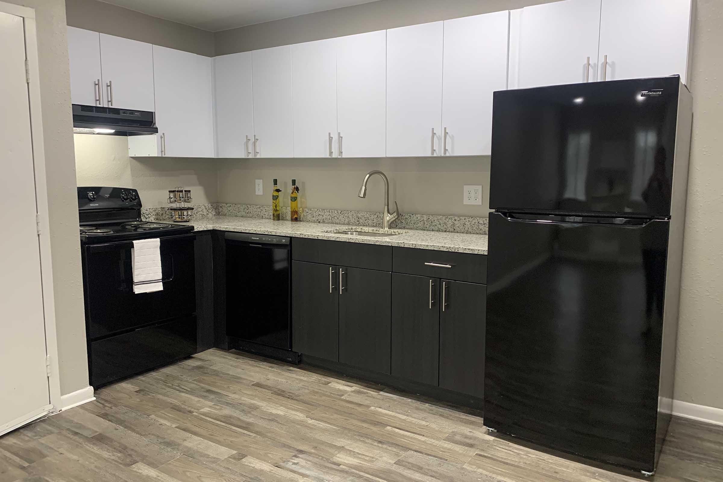 a kitchen with a sink and a refrigerator