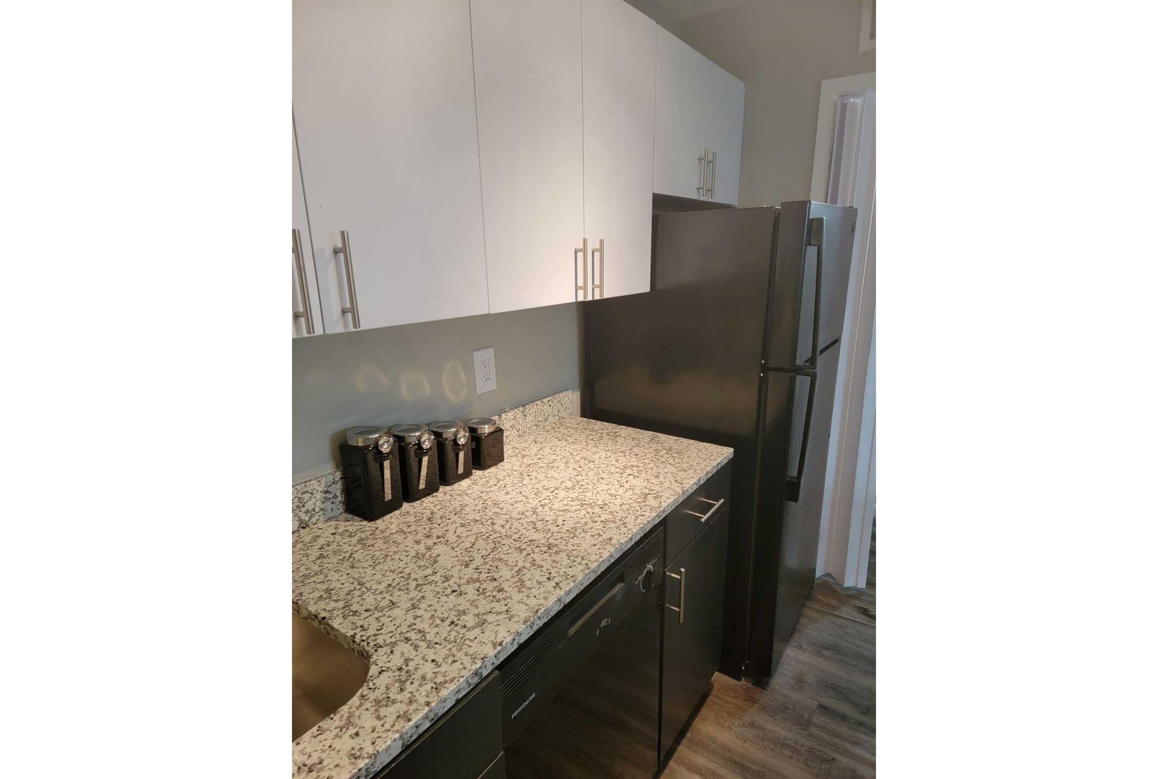 a kitchen with a sink and a mirror