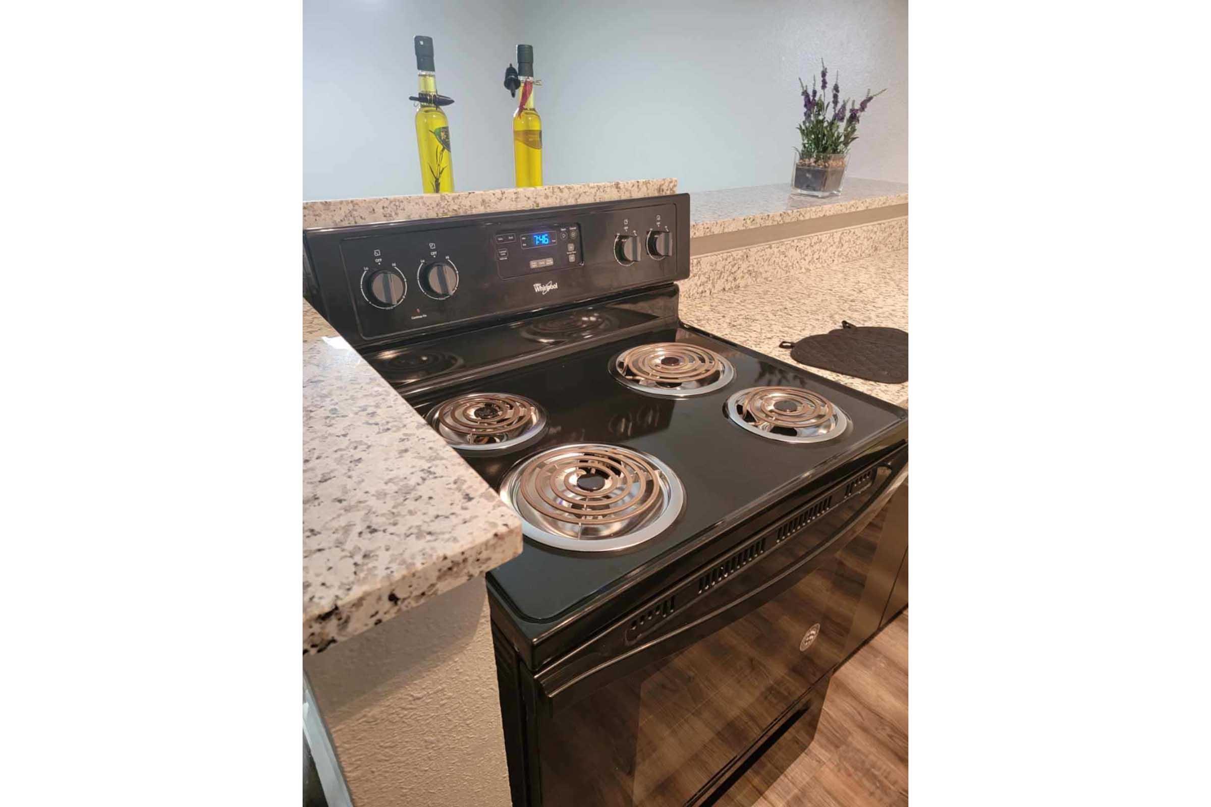 a stove top oven sitting inside of a kitchen