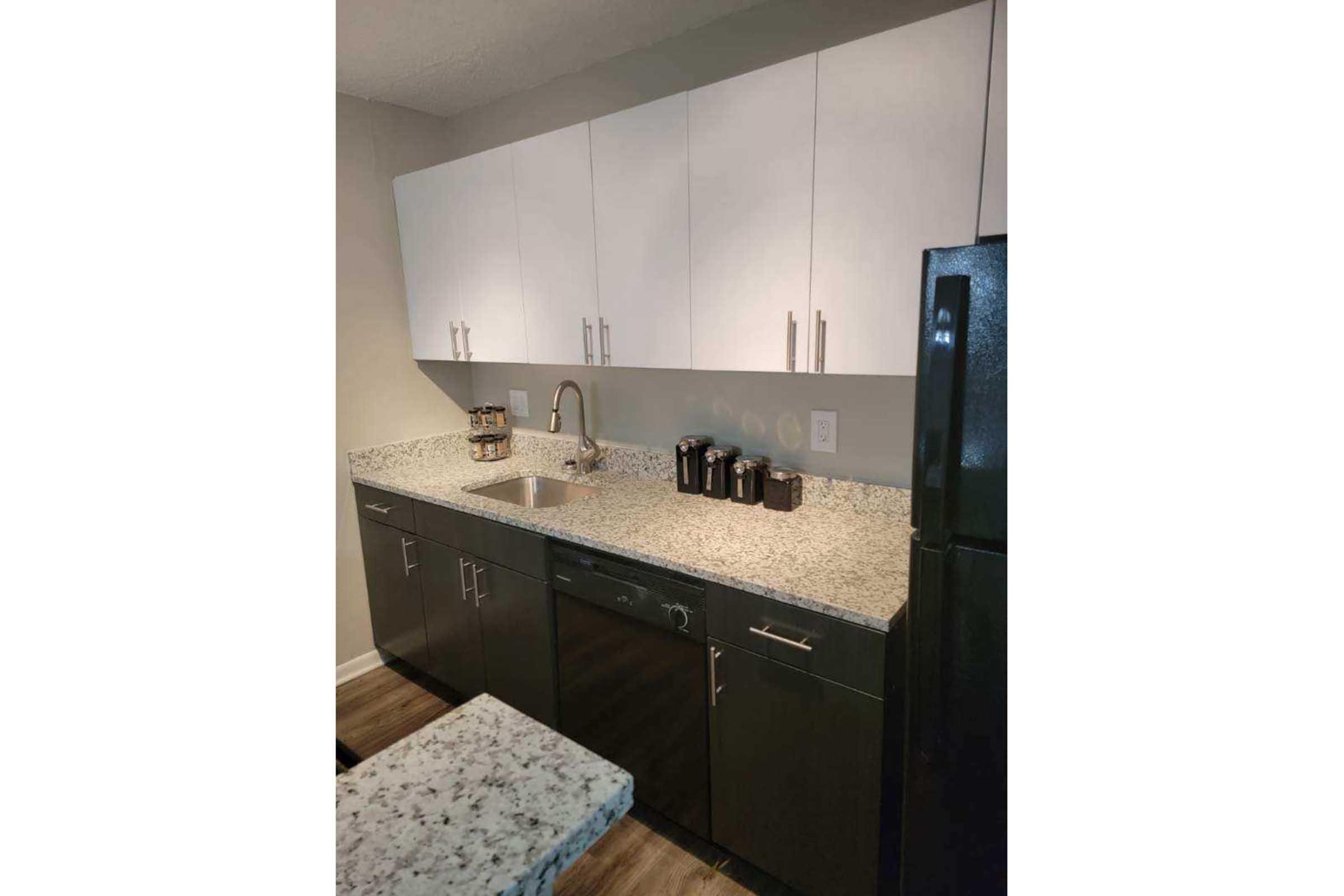 a kitchen with a sink and a mirror