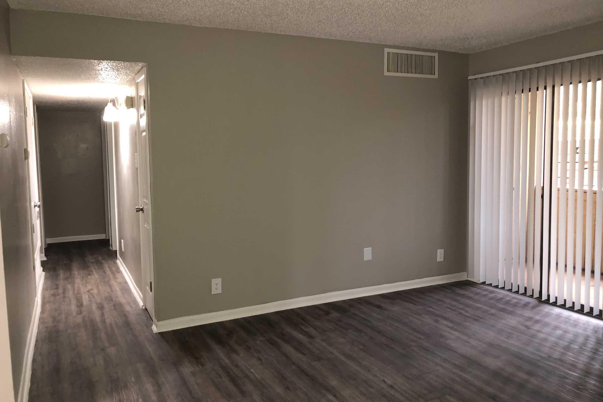 a large empty room with a wooden floor