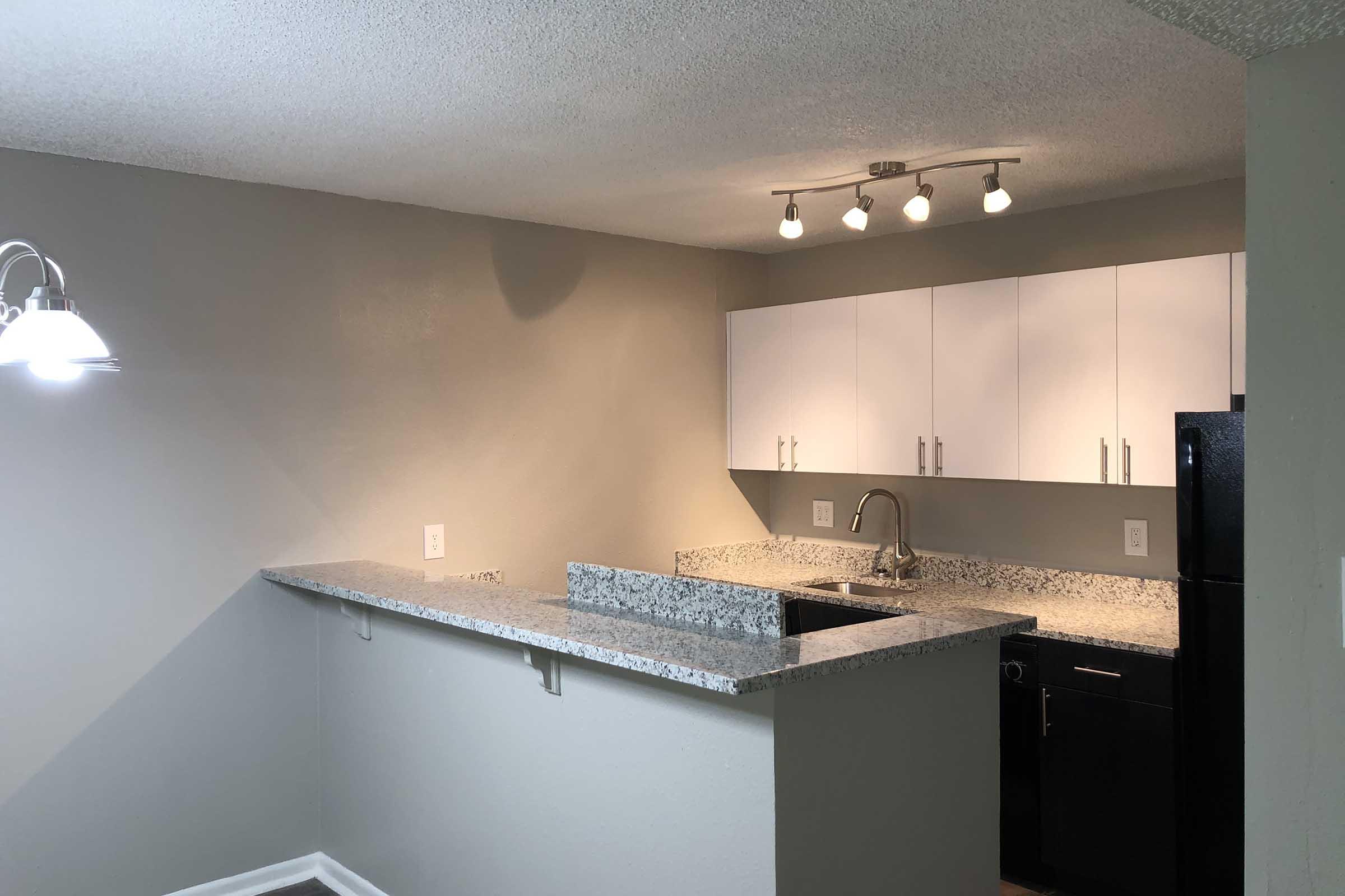 a kitchen with an island in the middle of a room