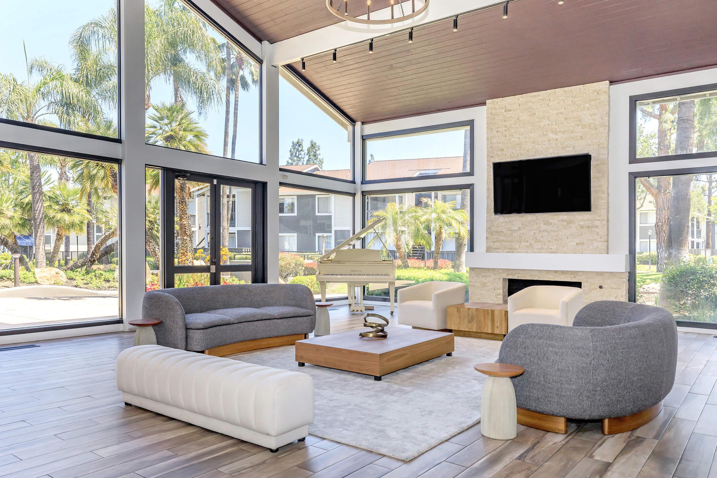 a living room filled with furniture and a large window