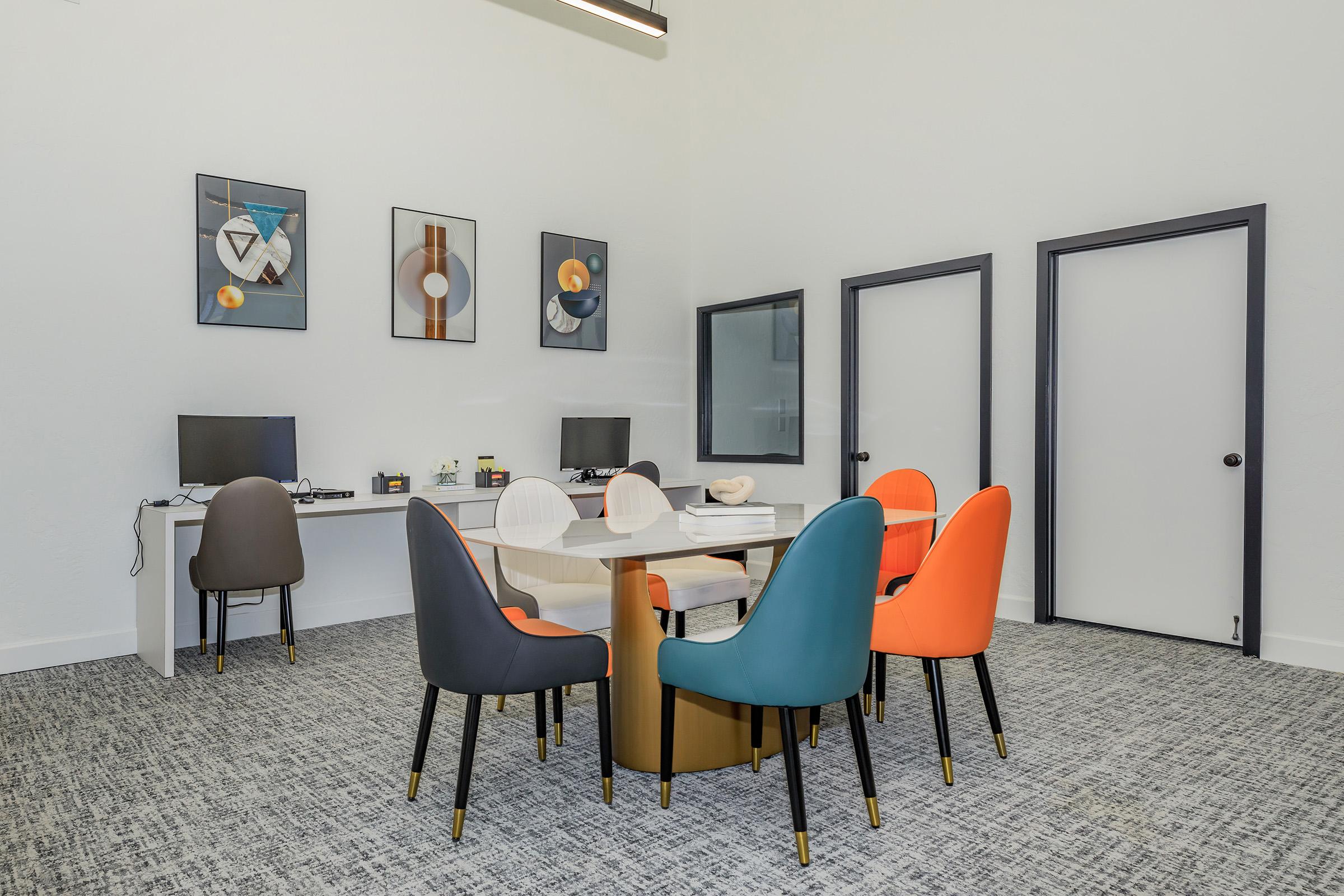 a living area with a desk and chair in a room