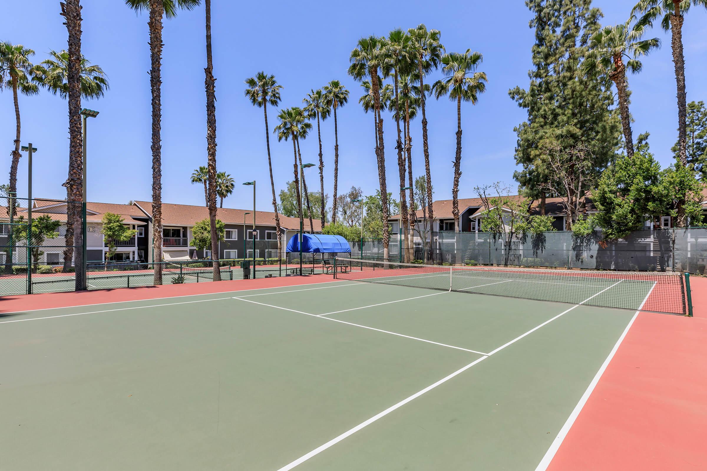 a group of people on a court with a racket