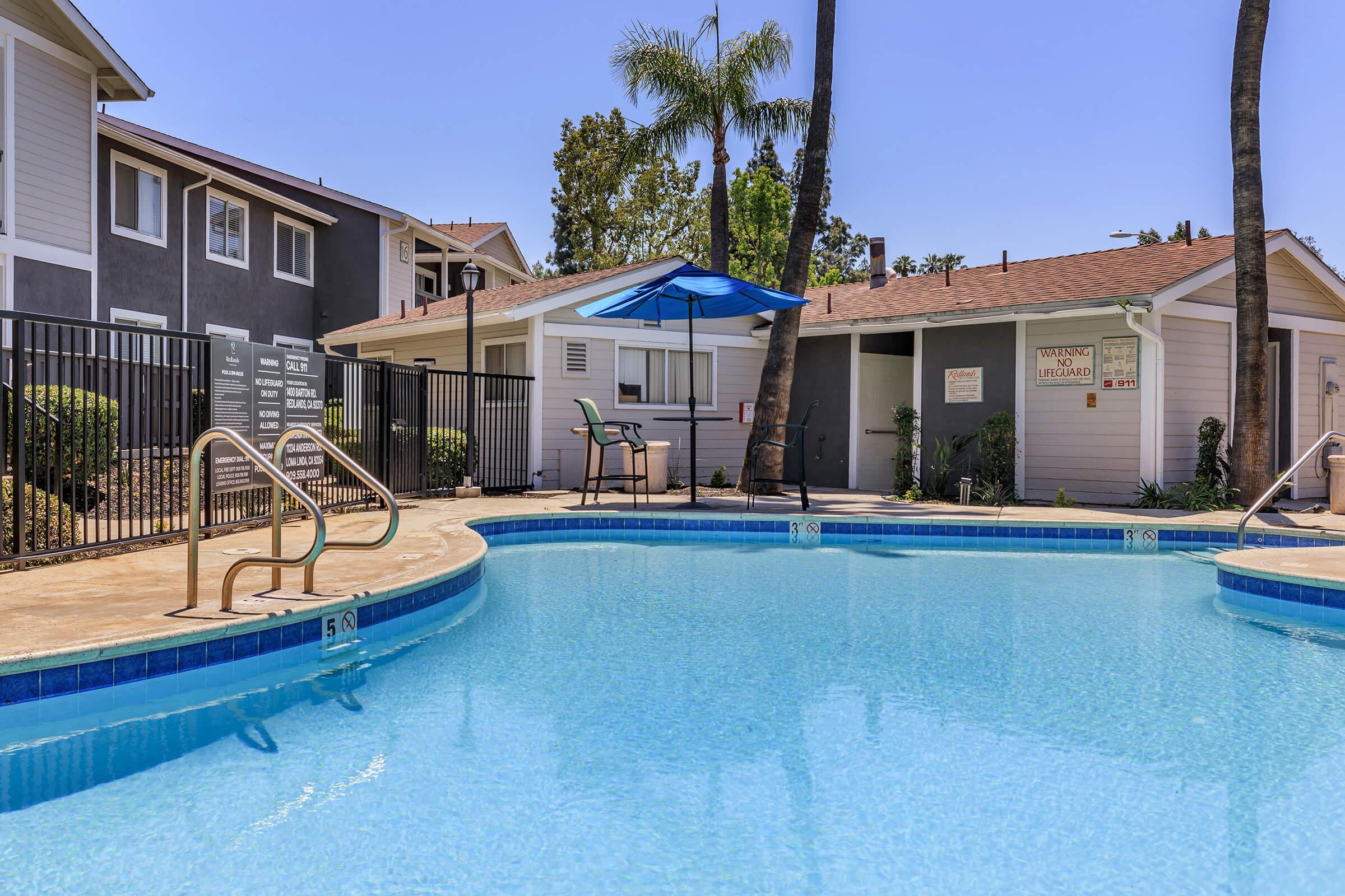 a blue pool of water in front of a house