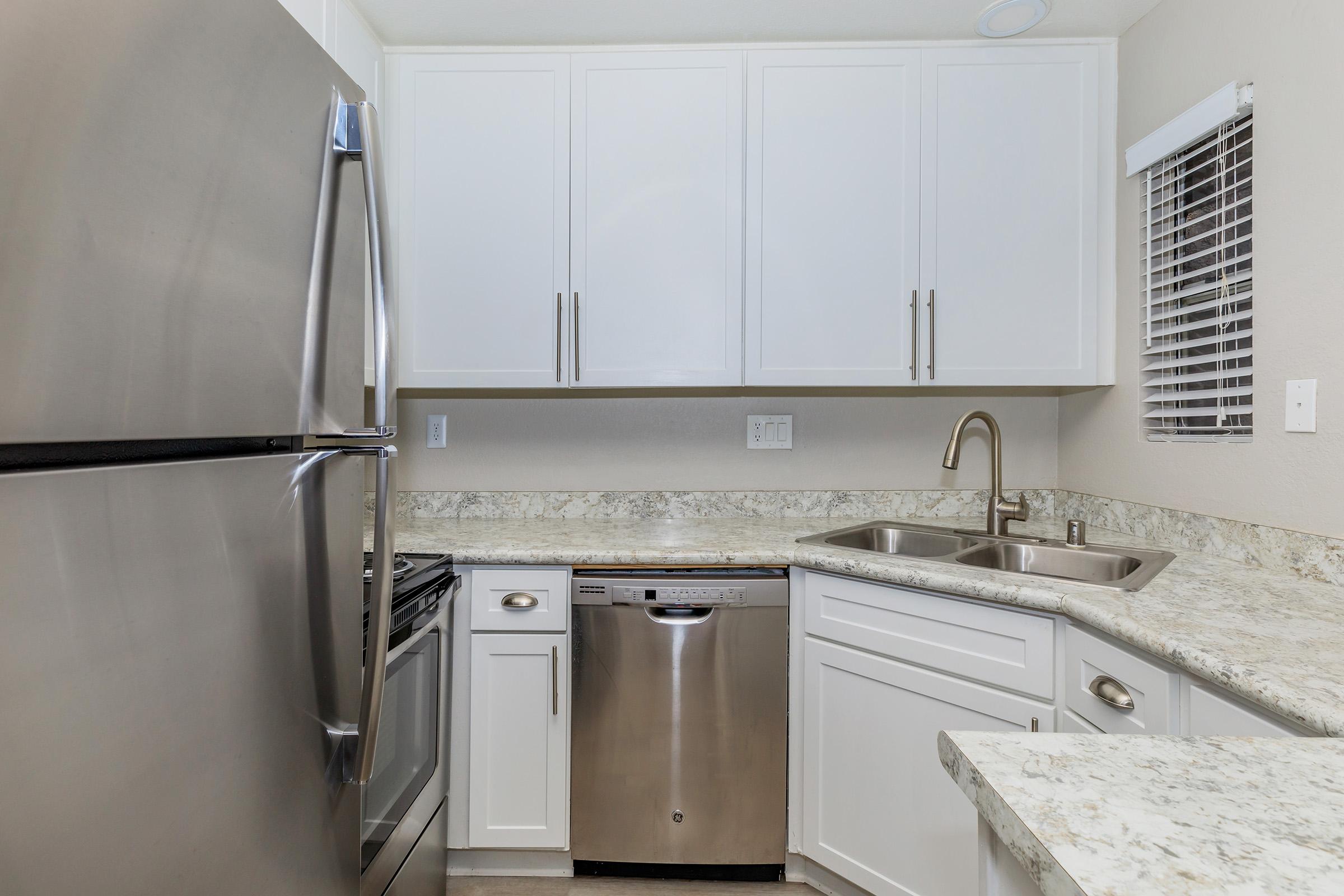 a kitchen with a sink and a refrigerator