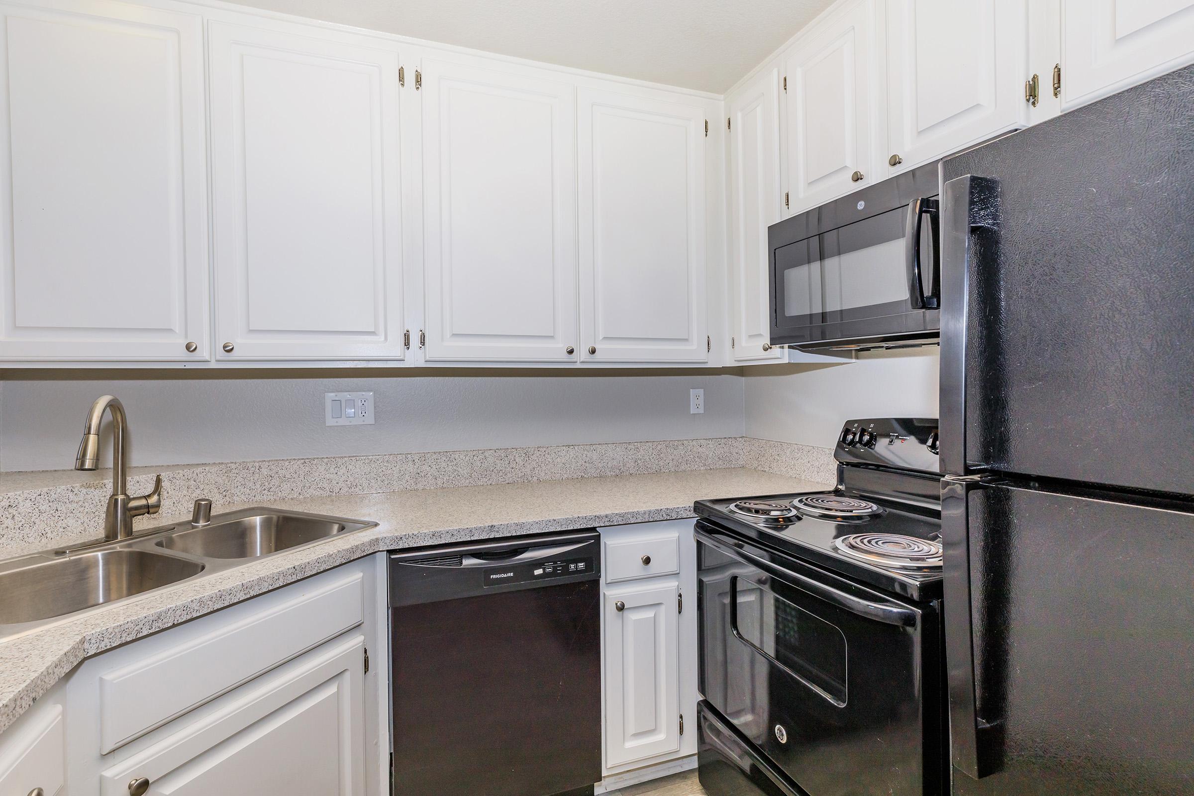 a stove top oven sitting inside of a kitchen