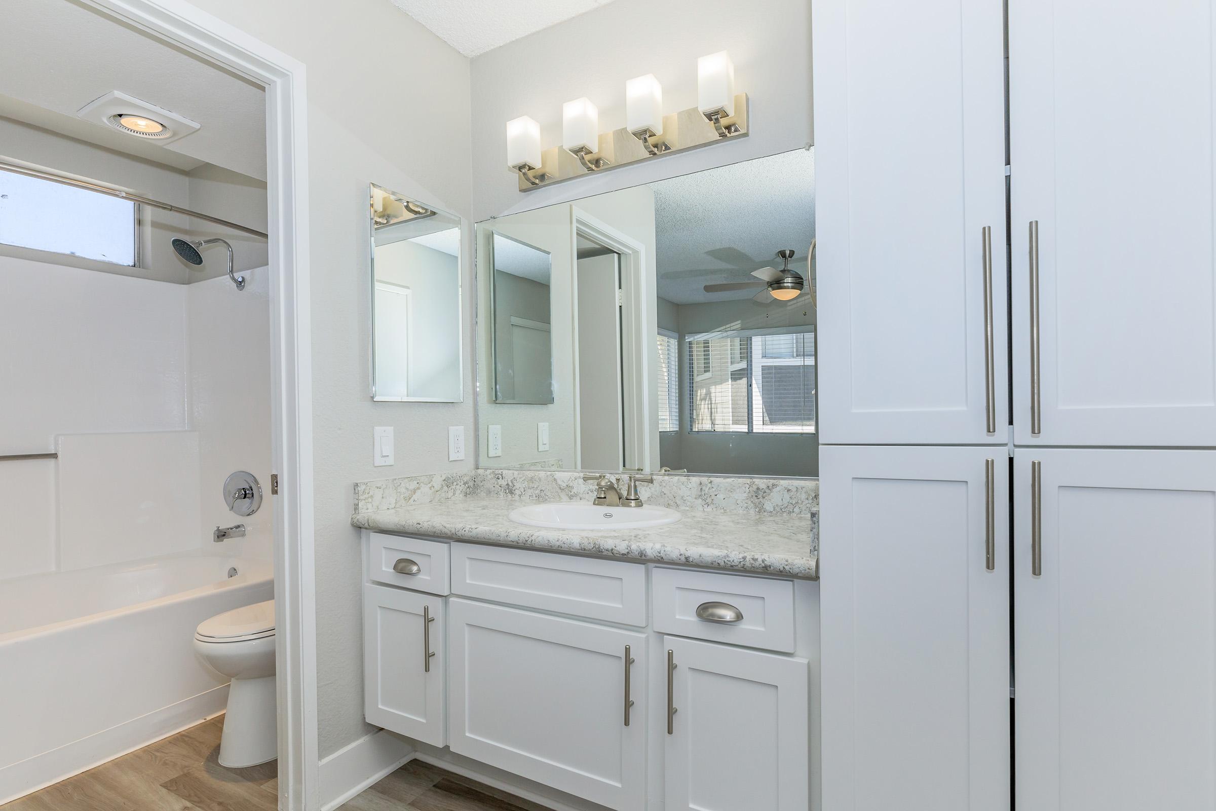 a kitchen with a sink and a mirror