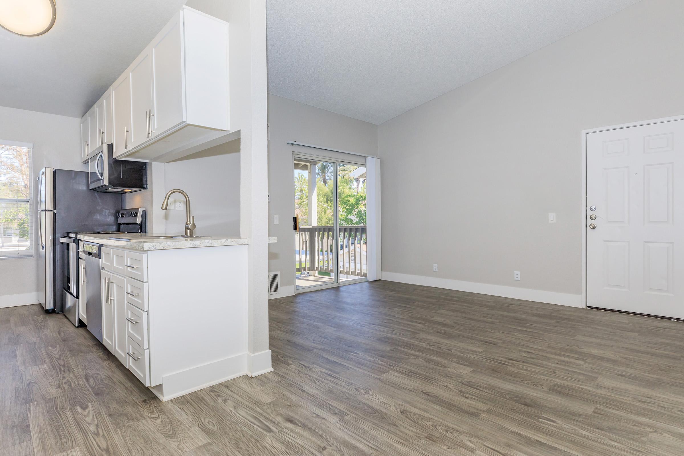 a kitchen with a refrigerator in a room