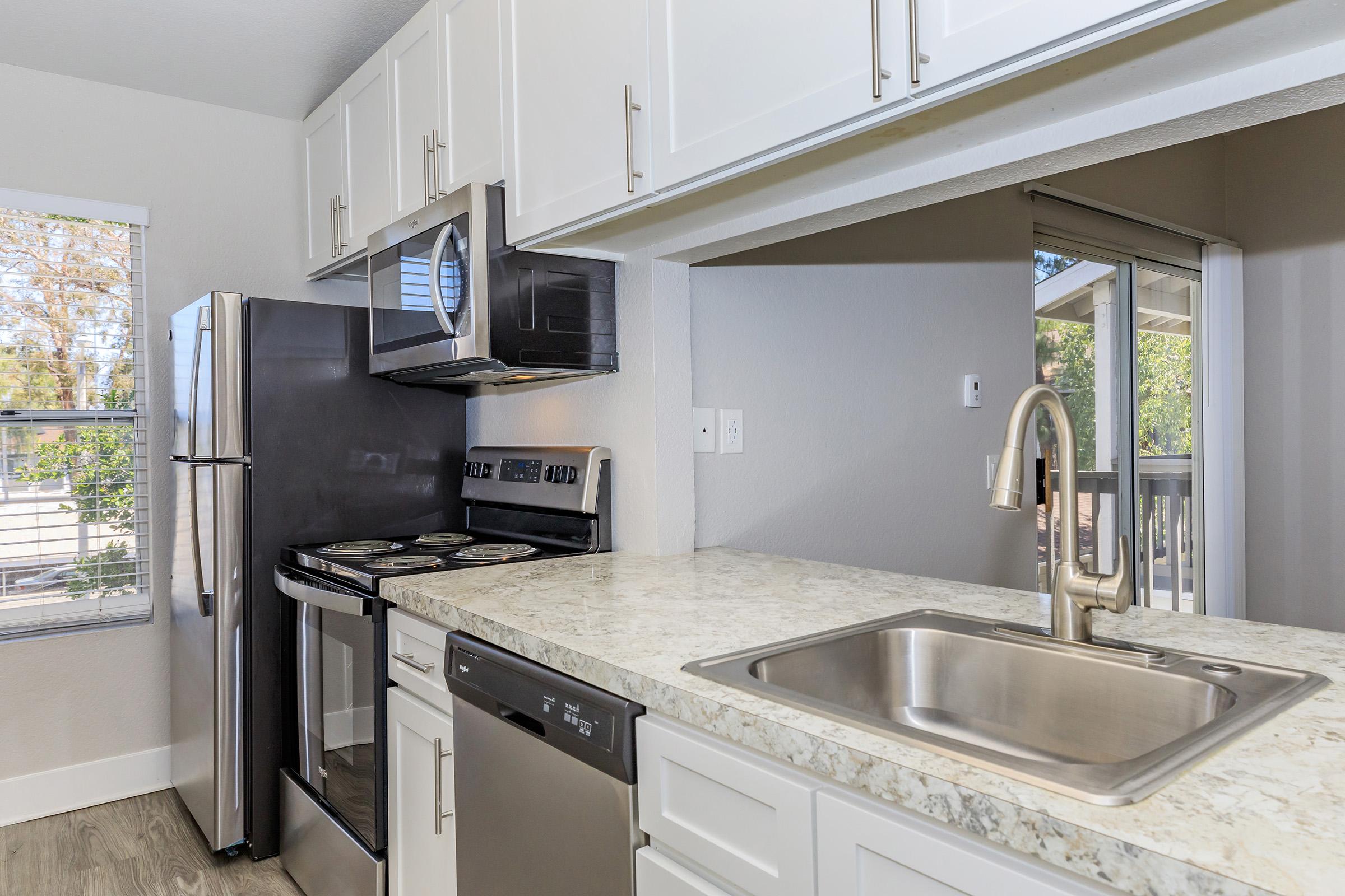 a large kitchen with stainless steel appliances