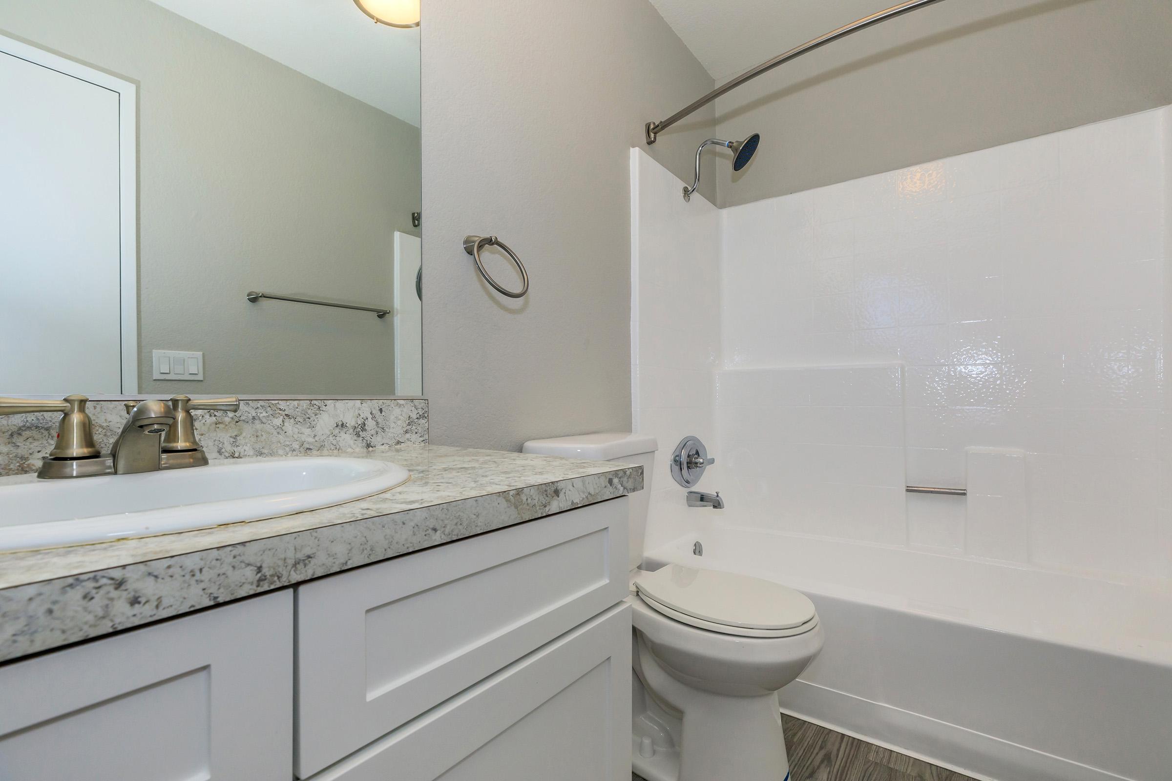 a kitchen with a sink and a mirror