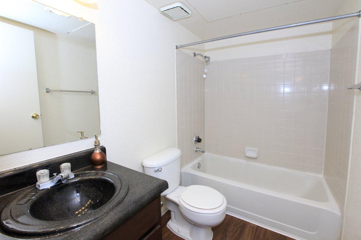 a white tub sitting next to a sink