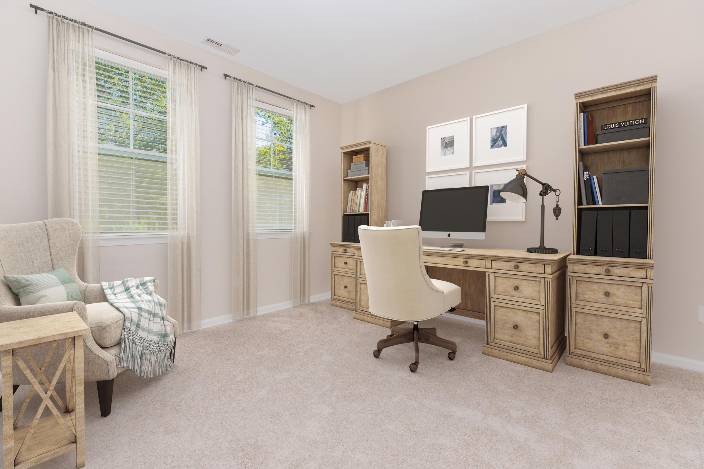 A well-decorated home office featuring a wooden desk with a computer, a comfortable office chair, and decorative shelves. There’s a cozy armchair in the corner with a throw blanket, large windows with light curtains, and neutral-colored walls and carpet, creating a bright and inviting workspace.