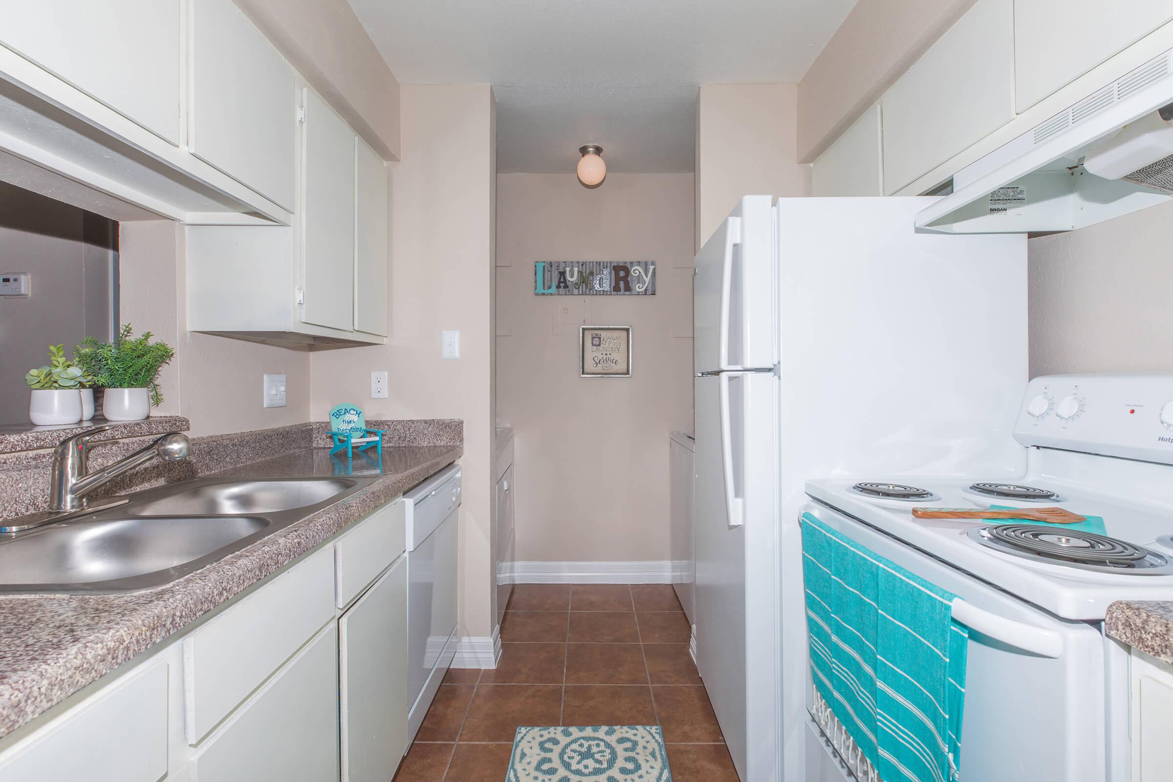 a kitchen with a stove sink and refrigerator