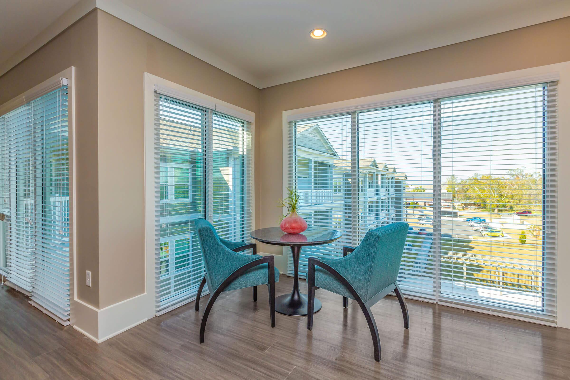 a living room filled with furniture and a large window