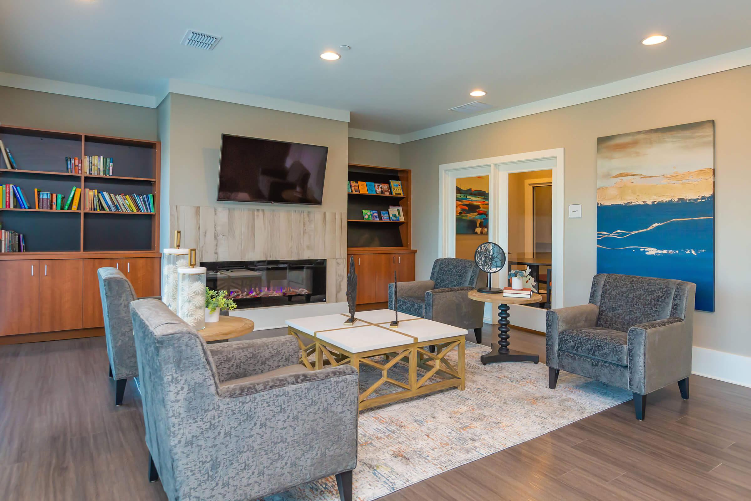 a living room filled with furniture and a large window