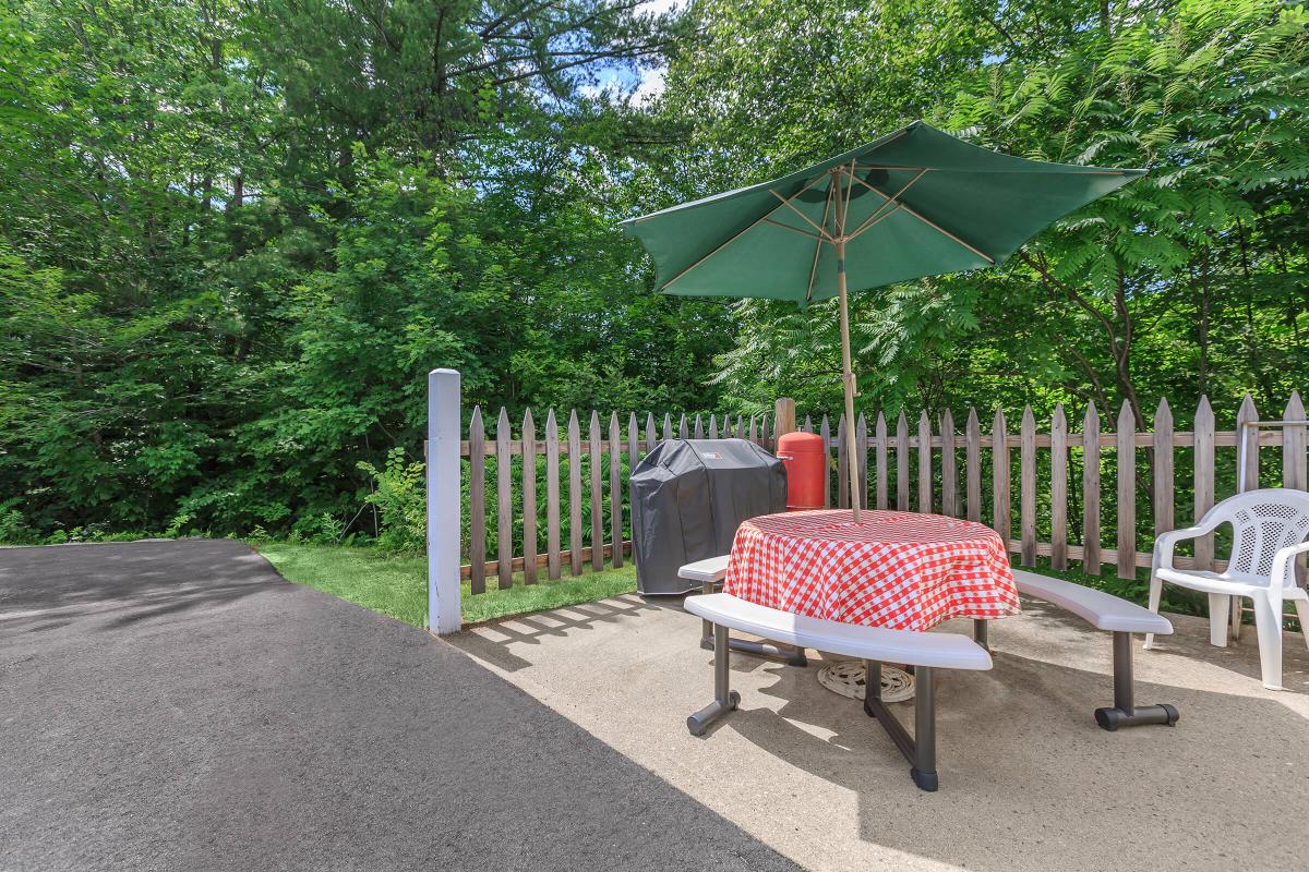 a red white and blue umbrella sitting on a bench