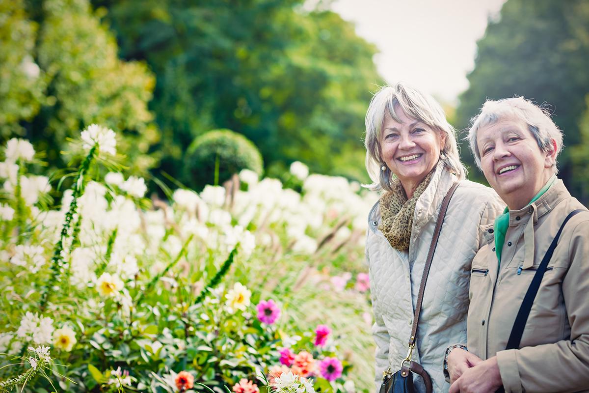 a person standing in a garden smiling