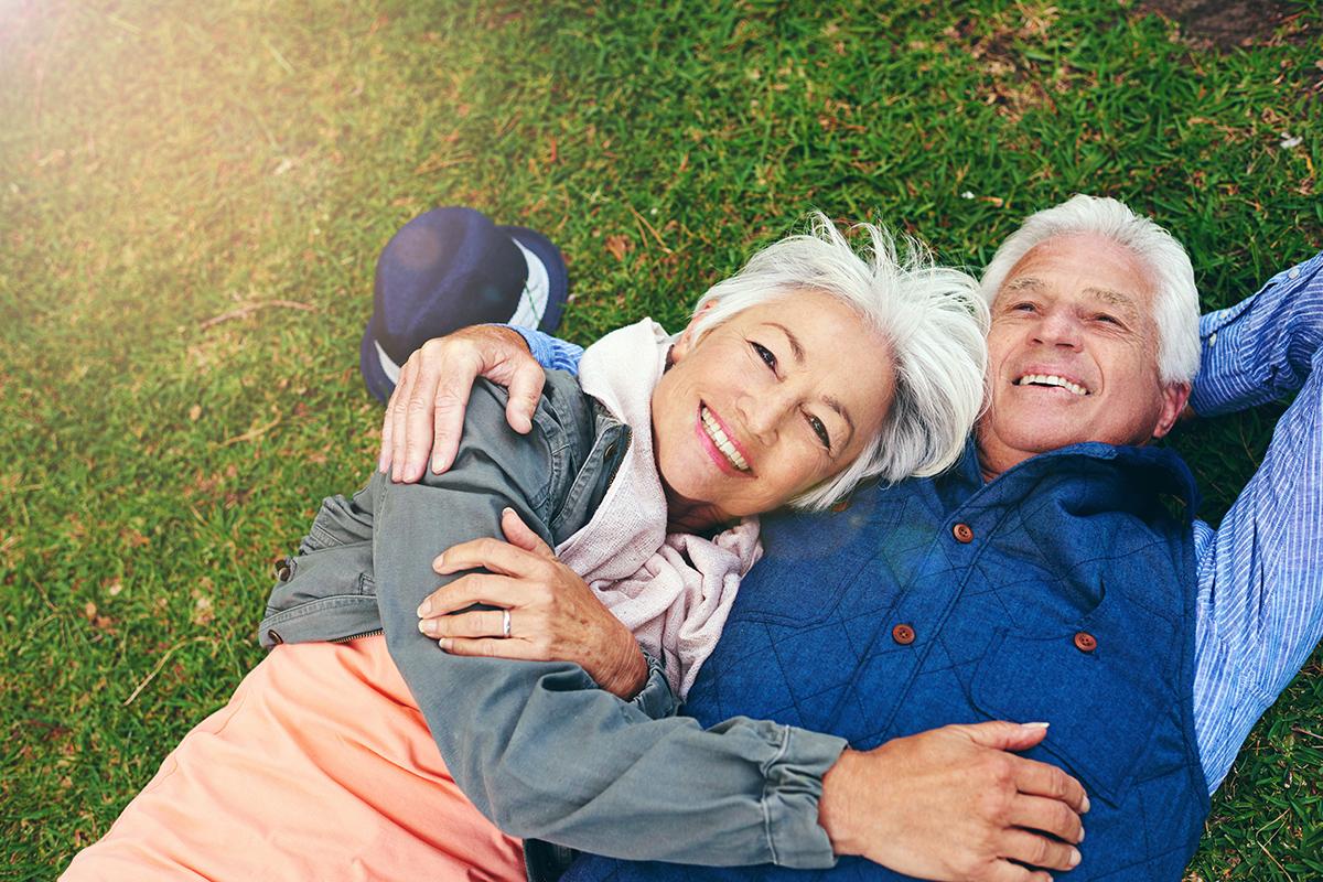 a group of people sitting in the grass