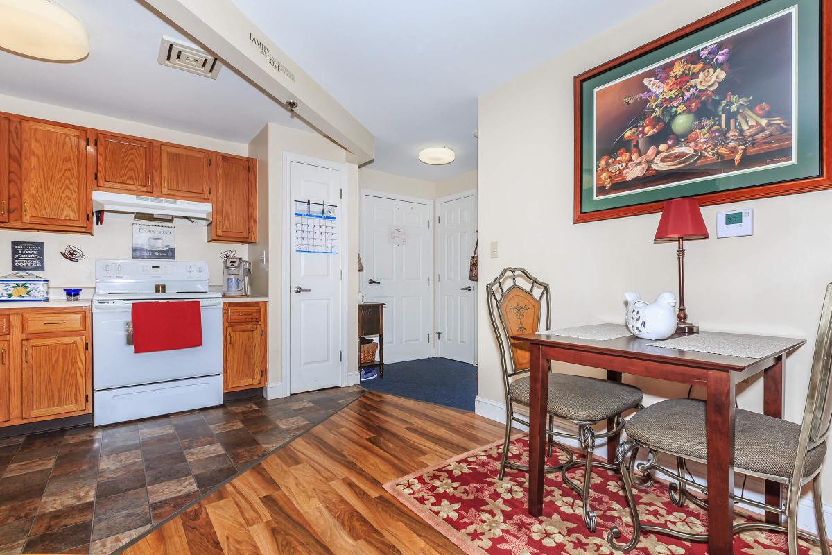 a kitchen with a wood floor in a room