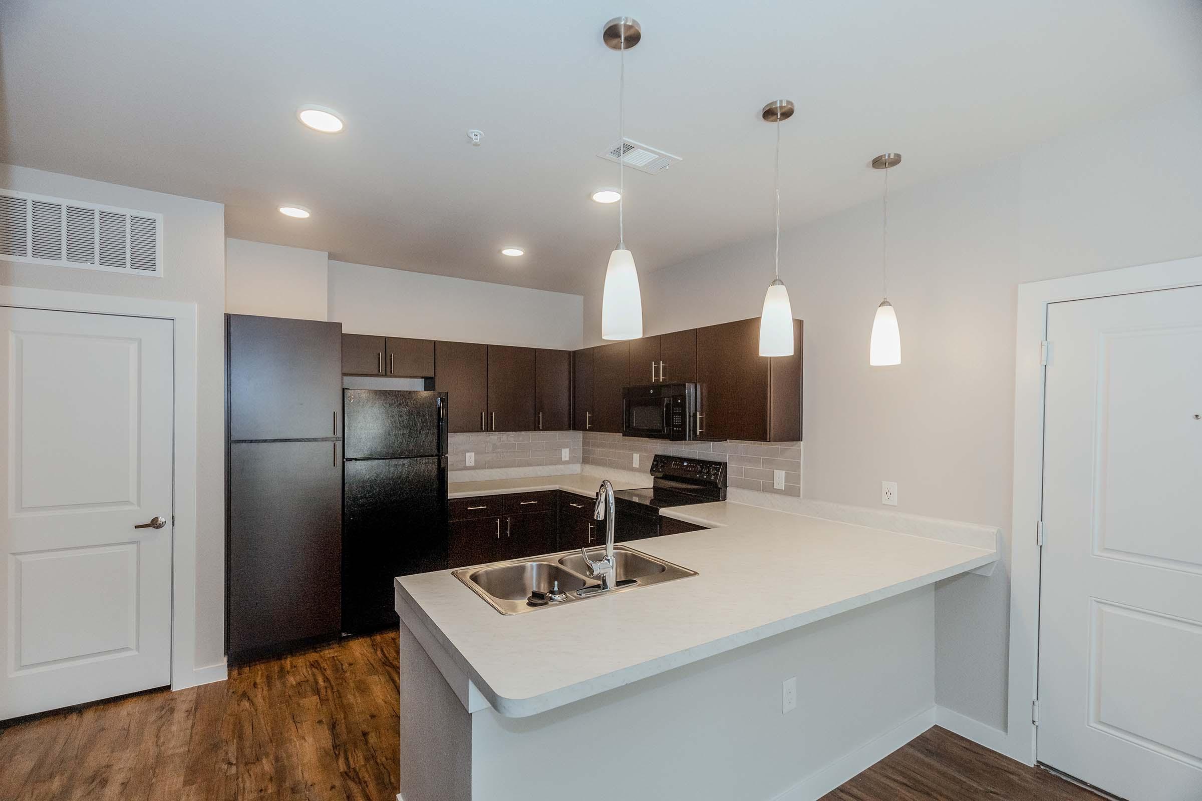 a kitchen with a sink and a mirror