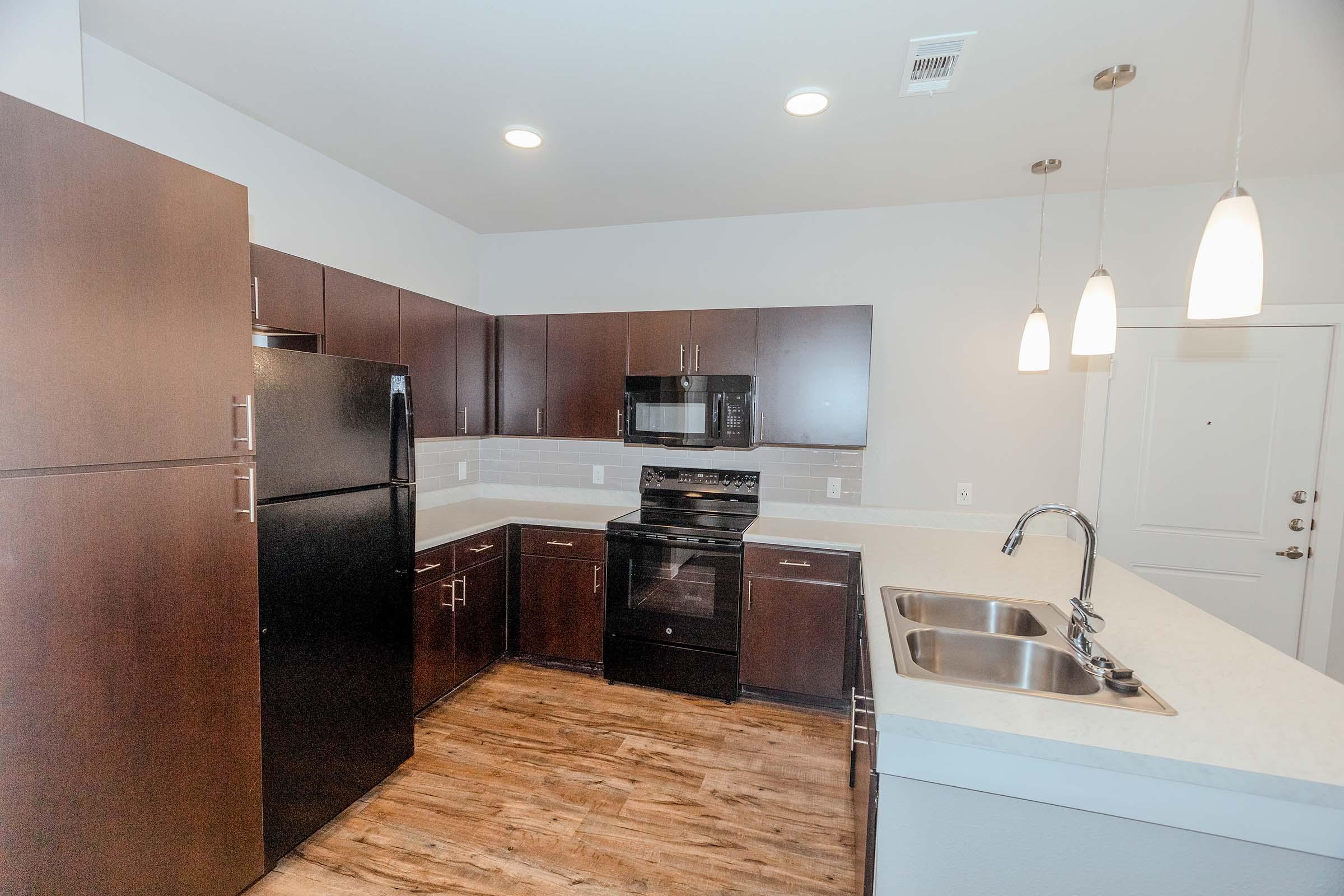 a kitchen with a sink and a refrigerator