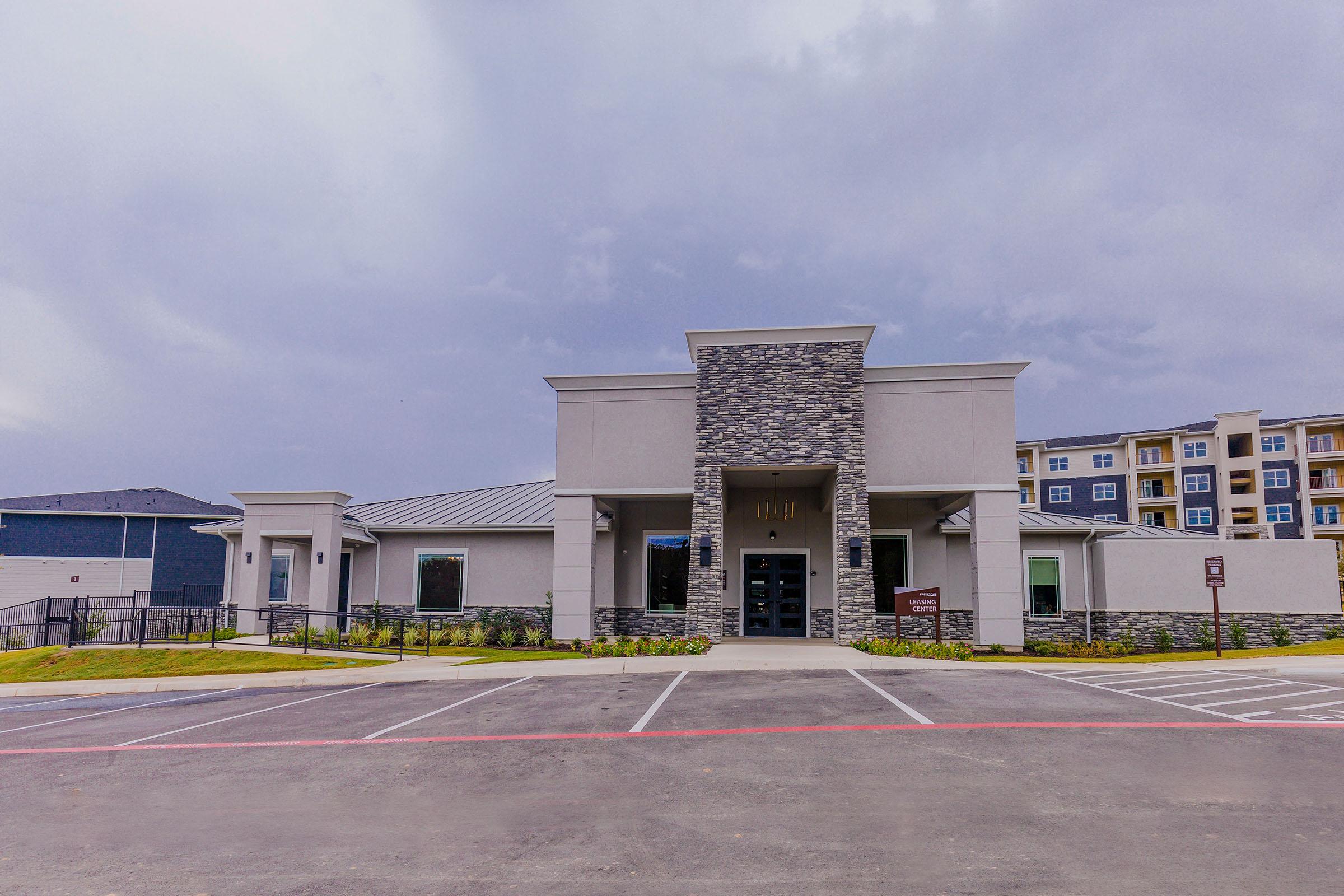 an empty parking lot in front of a building