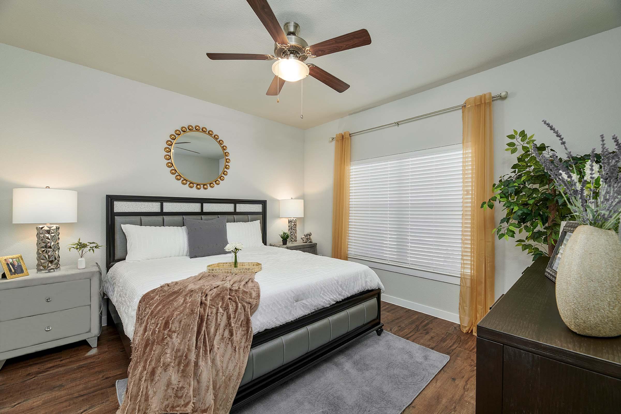 a bedroom with a bed and desk in a room