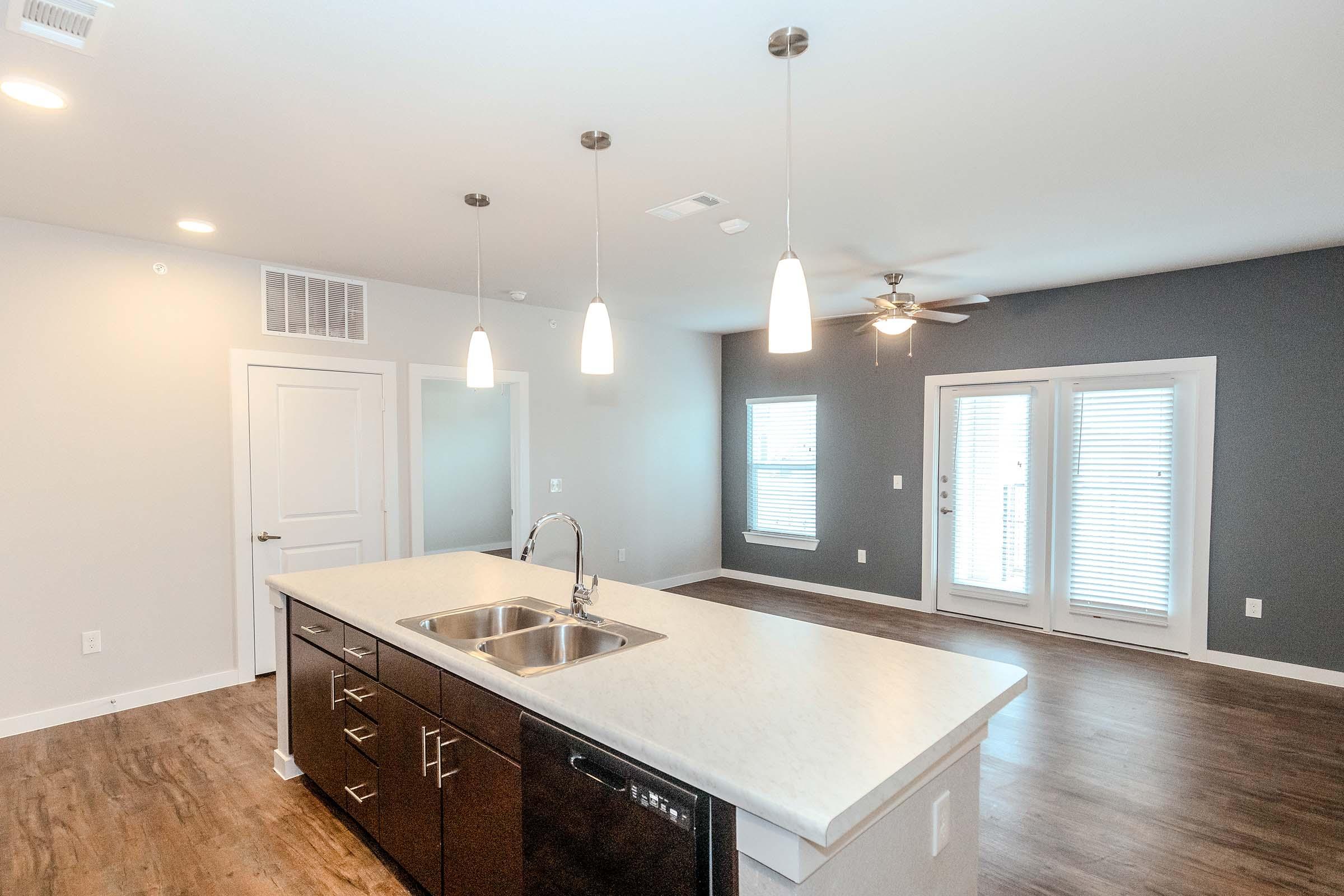 a kitchen with a sink and a mirror