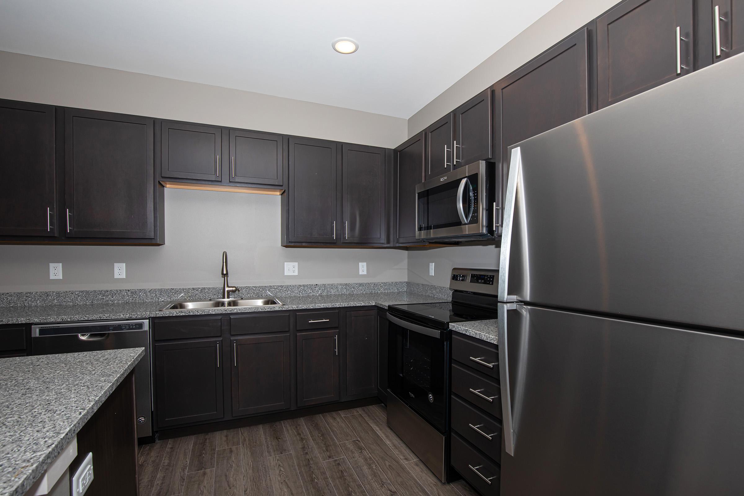 a large kitchen with stainless steel appliances