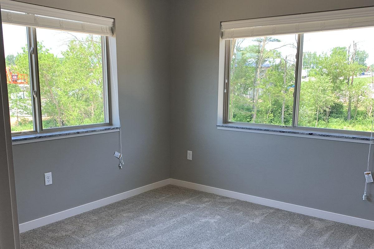 a bedroom with a large window