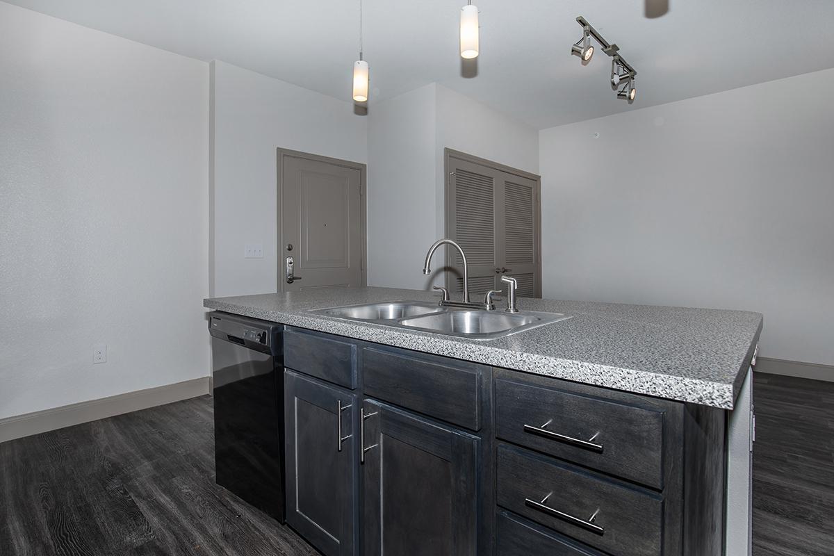 a kitchen with a sink and a mirror