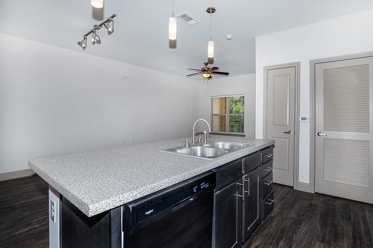 a kitchen with a sink and a mirror