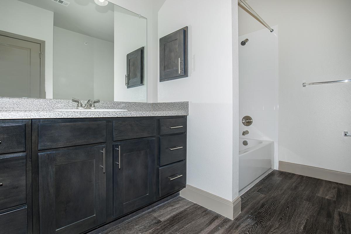 a kitchen with a sink and a mirror