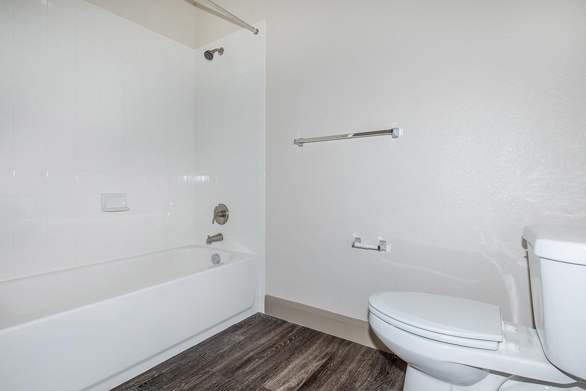 a large white tub sitting next to a shower