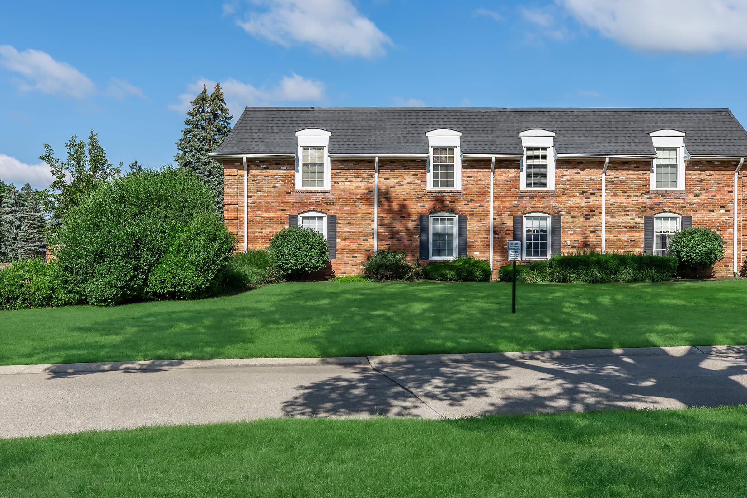 a building with a grassy field