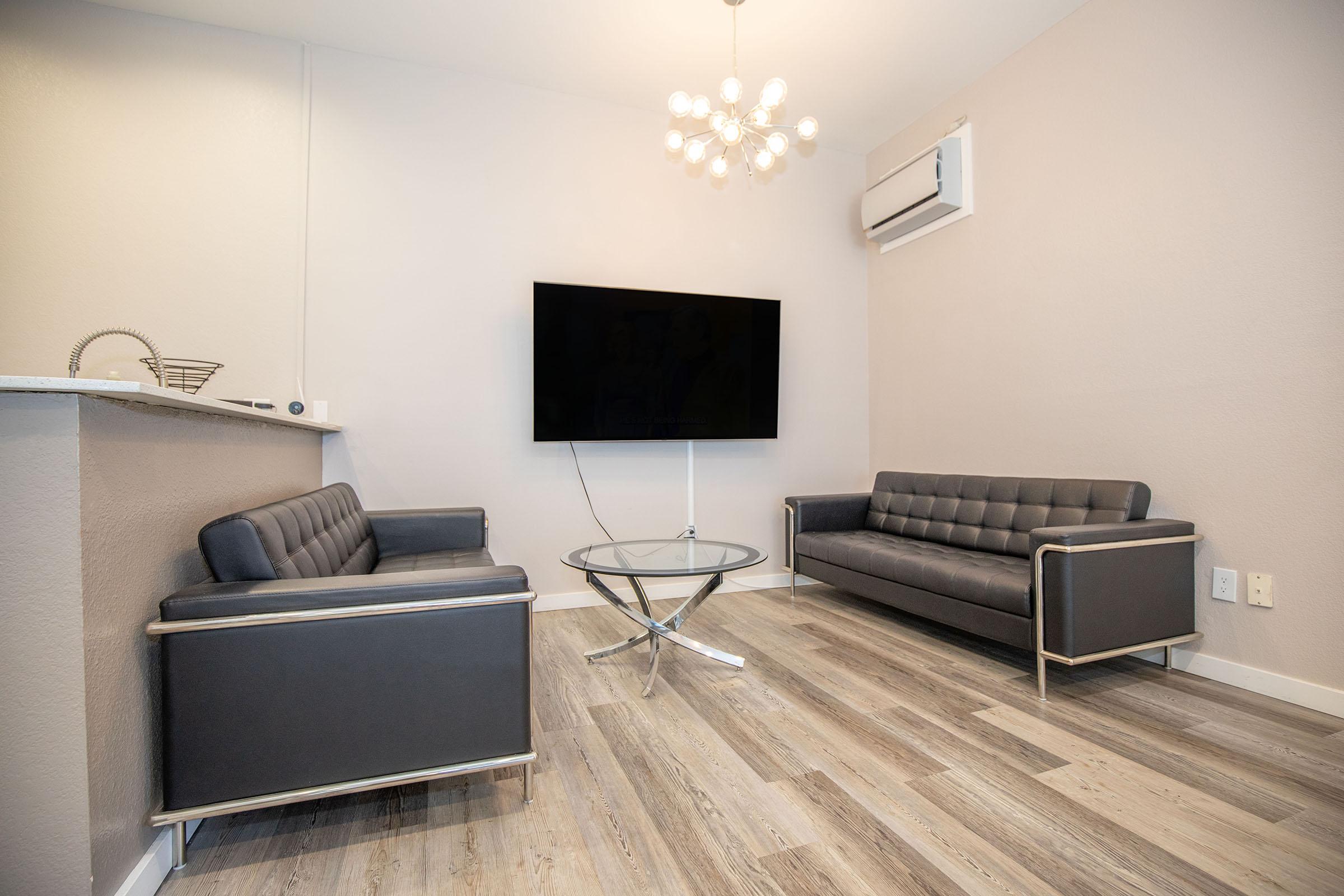 a living room filled with furniture and a flat screen tv